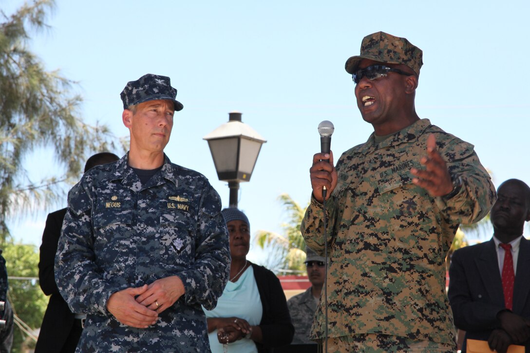 Gunnery Sgt. Felder Domond, a native of Port-au-Prince, Haiti, and translator for Navy Capt. Thomas M. Negus, commodore of Continuing Promise 2010, speaks Creole to Haitians during a Friendship Ceremony, Aug. 2, 2010, in Port-de-Paix, Haiti. Marines and Sailors of the USS Iwo Jima spent ten days in Port-de-Paix and Saint-Louis de Nord providing medial, dental, optometry and engineering assistance to Haitian citizens.