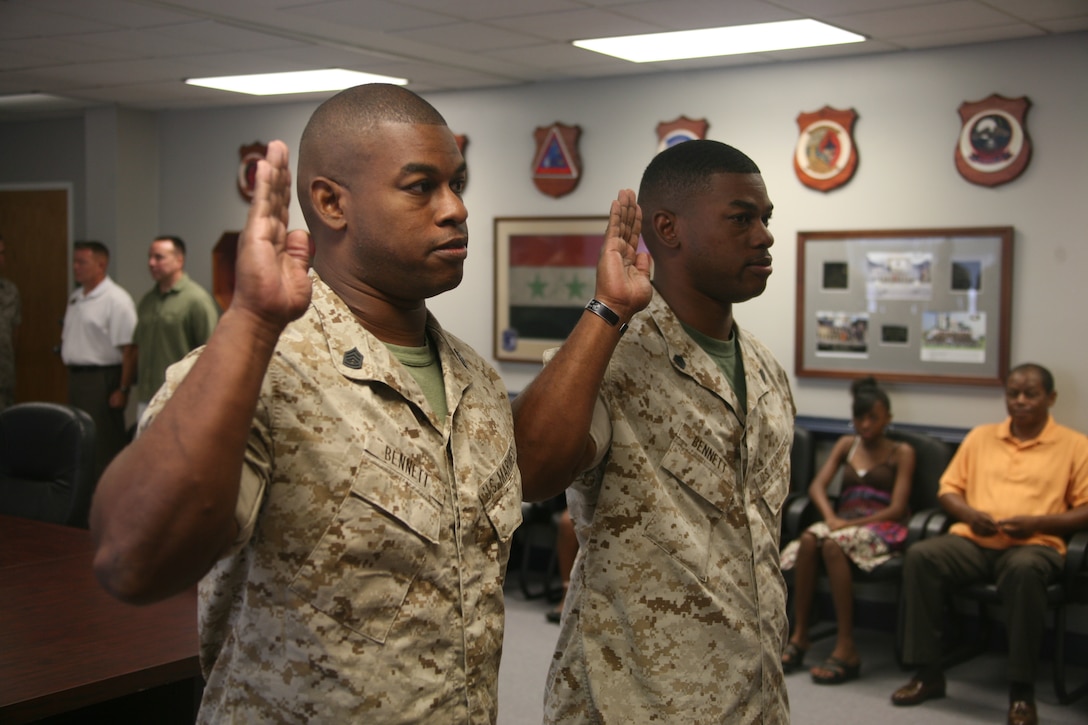 Gunnery Sergeants Terence and Terrell Bennett, identical twins, recite the military oath of enlistment during their promotion ceremony at Marine Air Control Group 28 Aug. 2. Terrell is the intelligence chief for MACG-28 at Marine Corps Air Station Cherry Point and Terence is an ammunition technician for Weapons Training Battalion, Quantico, Va.