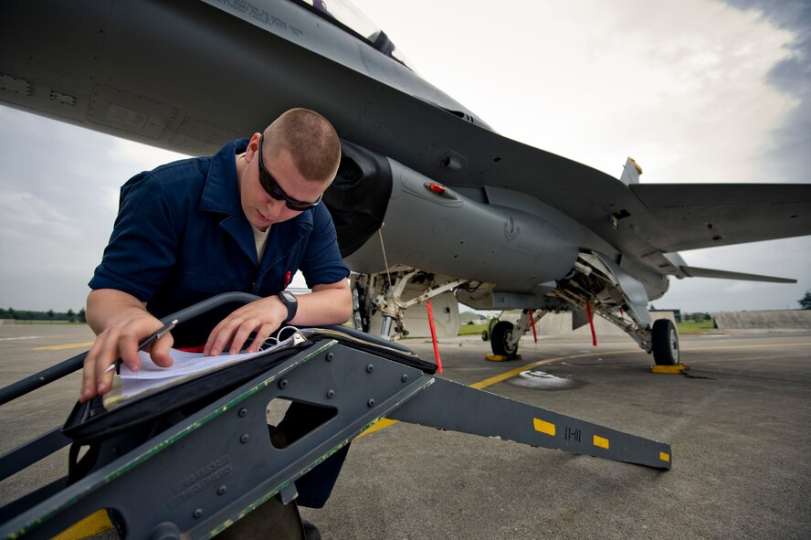 MISAWA AIR BASE, Japan -- Airman 1st Class Patric Shaw, 13th Aircraft Maintenance Unit completes maintenance logs on an F-16 Fighting Falcon following a training sortie Aug. 2. Crewchiefs are required to maintain meticulous logs of aircraft operations and maintenance, promoting communication and continuity throughout the maintainers. (U.S. Air Force photo/Staff Sgt. Samuel Morse)