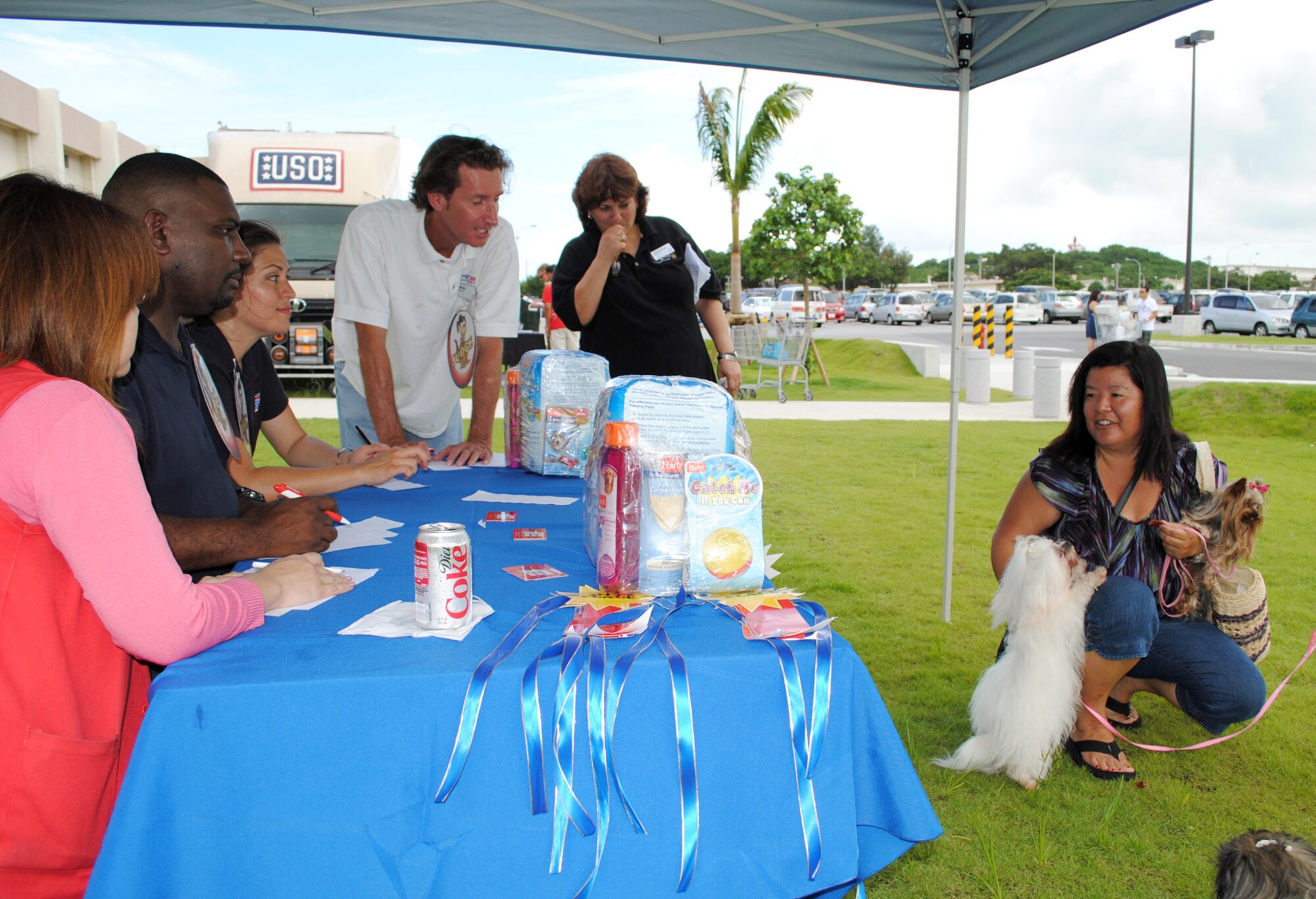 Military spouse, Debbie Tomas (right) answers questions from judges about her dogs, a Maltese named Belle and Coco, a Yorkie, July 31 during a dog show at the Kadena Base Exchange. (U,S. Army/Sgt. 1st Class Jon Cupp)
