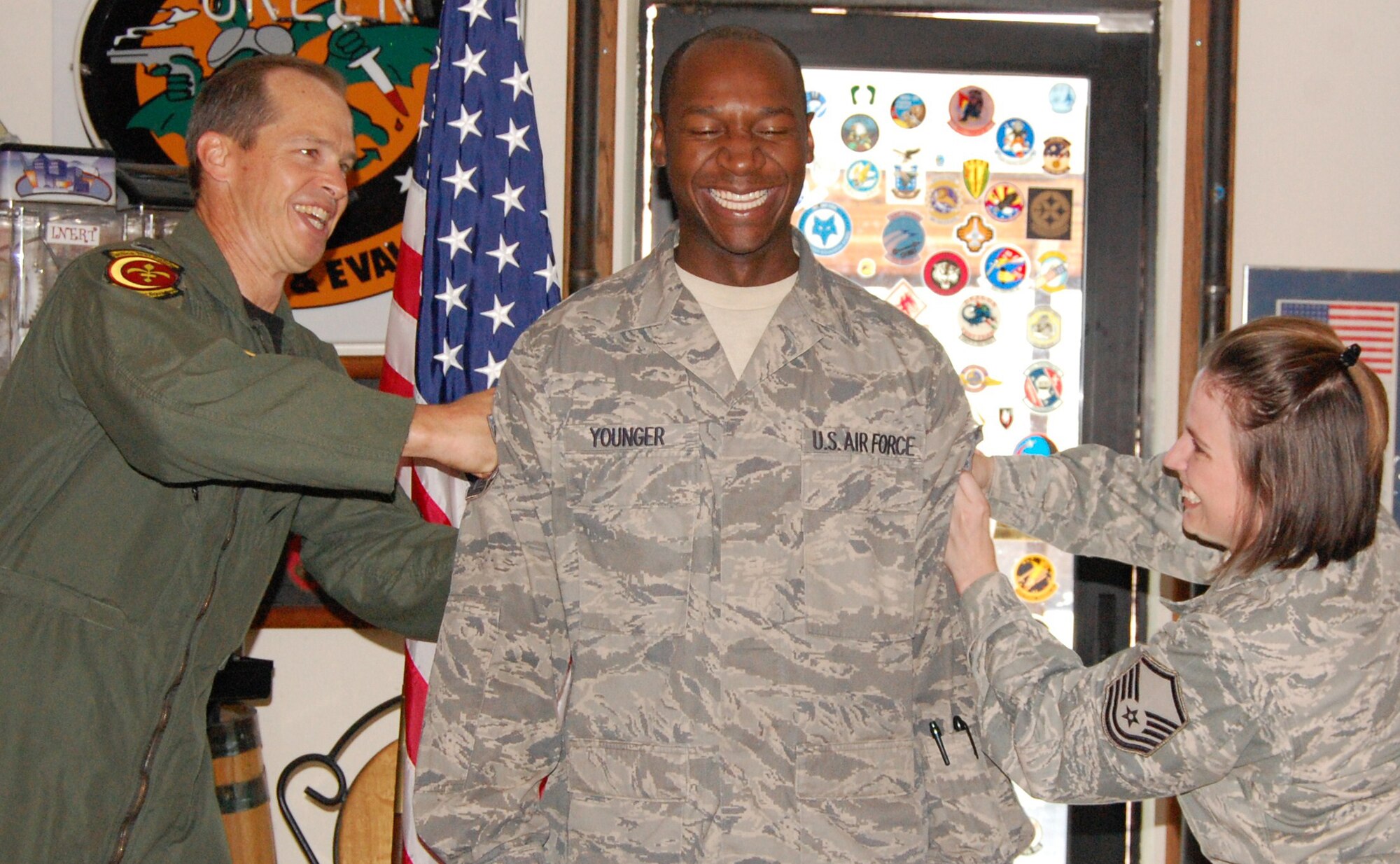 Newly promoted Master Sgt. Younger, center, gets his stripes "tacked" on by his wife Master Sgt. Younger, and Lt. Col. Jones, 706th Fighter Squadron commander, July 30 during a promotion ceremony at Nellis Air Force Base, Nev. Kevin is an assistant noncommissioned officer in charge of aircrew flight equipment with the 706th FS. Upon joining the Air Force Reserve in March 2008, he was assigned to work with the 422nd Test and Evaluation Squadron through Total Force Integration. The following 926th Group members were also promoted on Aug. 1: Master Sgt. Palmore, 706th FS; Master Sgt. Bluto, 78th Reconnaissance Squadron; and Master Sgt. Lonefors, 78th AS
