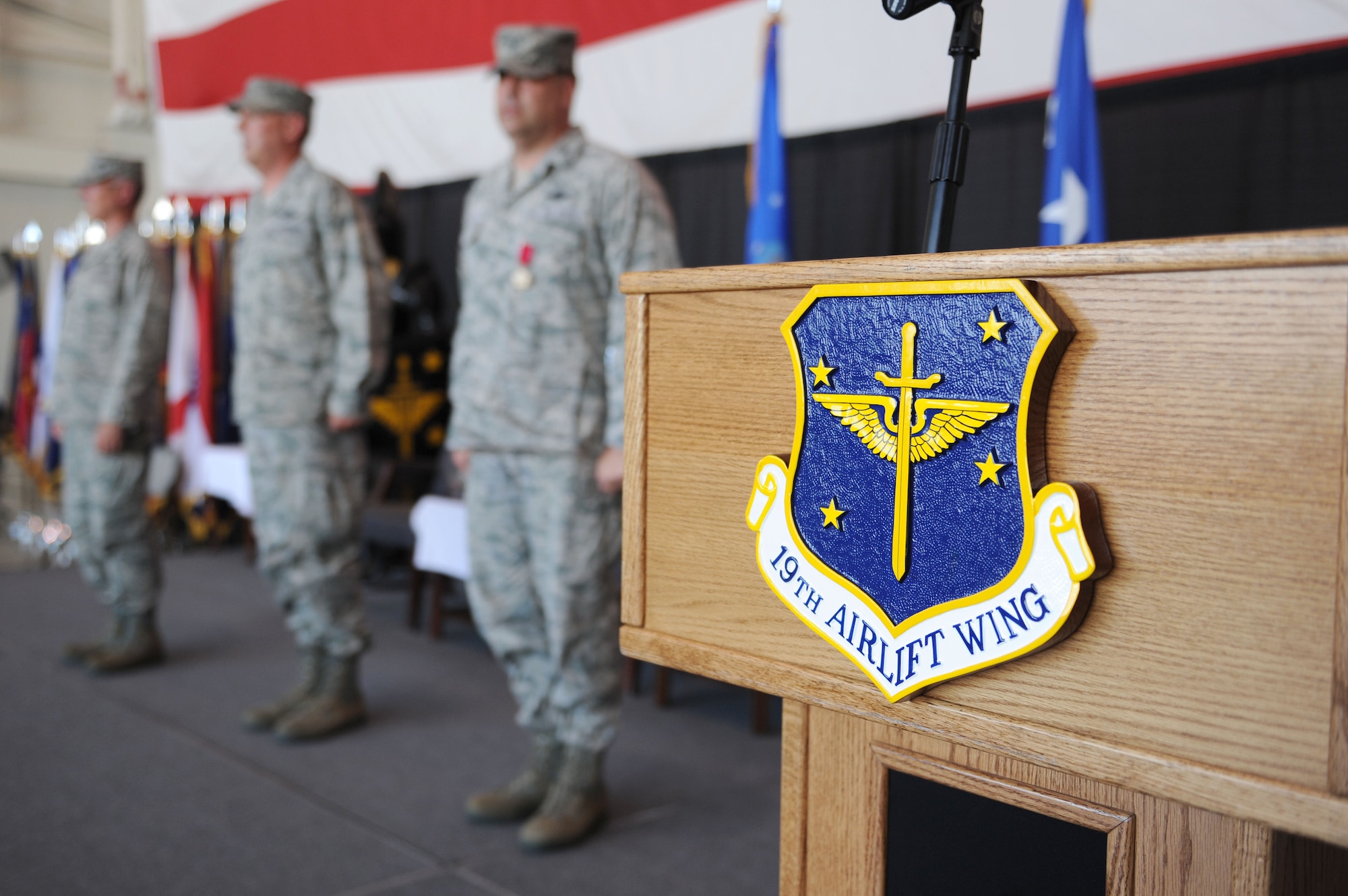 Lt. Gen. Robert Allardice (left), 18th Air Force commander, stands with Col. Michael Minihan, incoming 19th Airlift Wing commander, and Col. Greg Otey, outgoing 19th AW commander, during a change of command ceremony here Aug. 2. The 19th AW is the host unit to the largest C-130 base in the world.  (U.S. Air Force photo by Senior Airman Steele C.G. Britton)