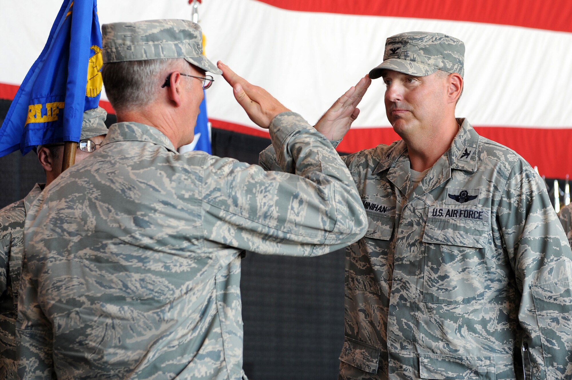 Col. Michael Minihan (right), 19th Airlift Wing commander, returns a salute to Lt. Gen. Robert Allardice, 18th Air Force commander, during a change of command ceremony here Aug. 2.  The 19th AW is the host unit to the largest C-130 base in the world.  (U.S. Air Force photo by Senior Airman Steele C.G. Britton)