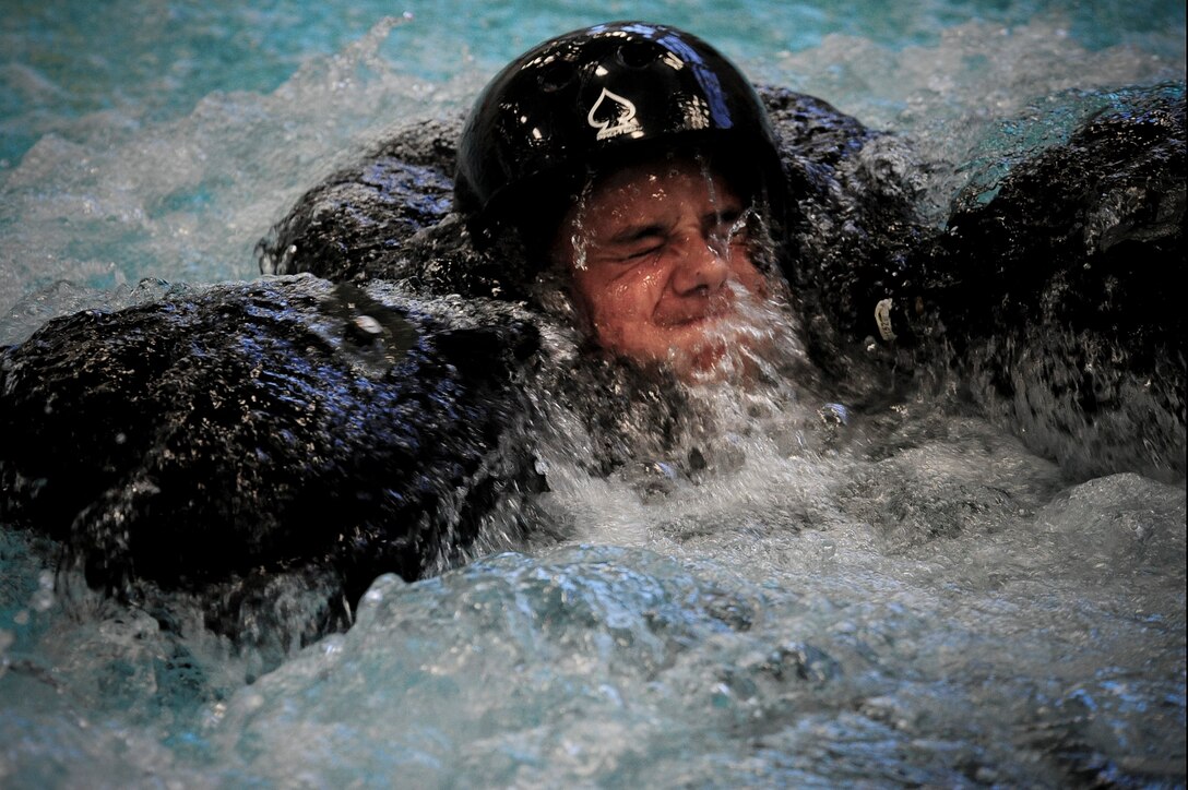 ELLSWORTH AIR FORCE BASE S.D. – A Junior Reserve Officers’ Training Corps member, performs in a parachute drag in the survival, evasion, resistance and escape water survival training while participating in a base tour, July 30. During the training, participants must unlatch themselves from the simulated parachute to successfully complete the parachute drag. (U.S. Air Force photo/Airman 1st Class Corey Hook)