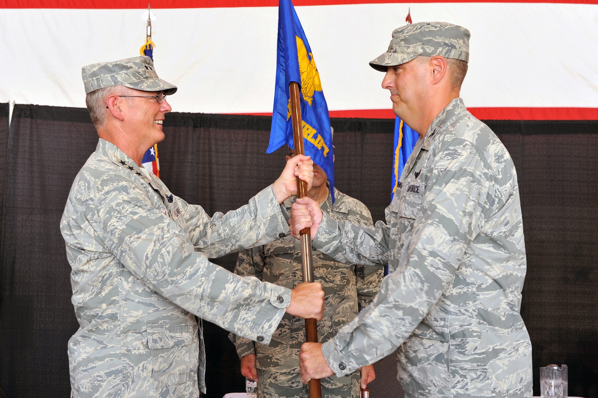 Lt. Gen. Robert Allardice, 18th Air Force commander, presents the 19th Airlift Wing guide-on to Col. Michael Minihan, 19th AW commander, during a change of command ceremony here Aug. 2. The 19th AW is the host unit to the largest C-130 base in the world.  (U.S. Air Force photo by Staff Sgt. Chris Willis)
