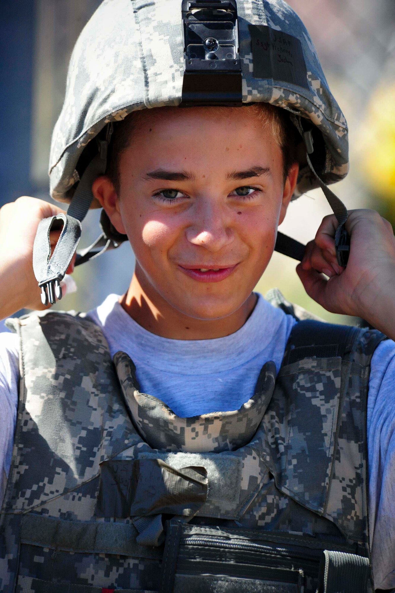 ELLSWORTH AIR FORCE BASE S.D. – A Junior Reserve Officers’ Training Corps member, puts on a kevlar helmet during a base tour, July 30. Kevlar helmets provide Airmen with blunt- trauma protection from impact with walls, vehicles, etc. (U.S. Air Force photo/Airman 1st Class Corey Hook)