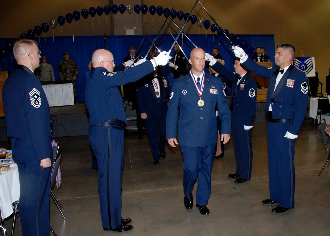 Fifty technical sergeants pass through an archway of swords, symbolizing their entry into the senior NCO tier during the Senior NCO Induction Ceremony July 30 at the Multi-purpose Event Center in Wichita Falls, Texas.  More than 400 of the inductee’s peers, supervisors, leadership and family were in attendance.  (U.S. Air Force photo/Harry Tonemah)