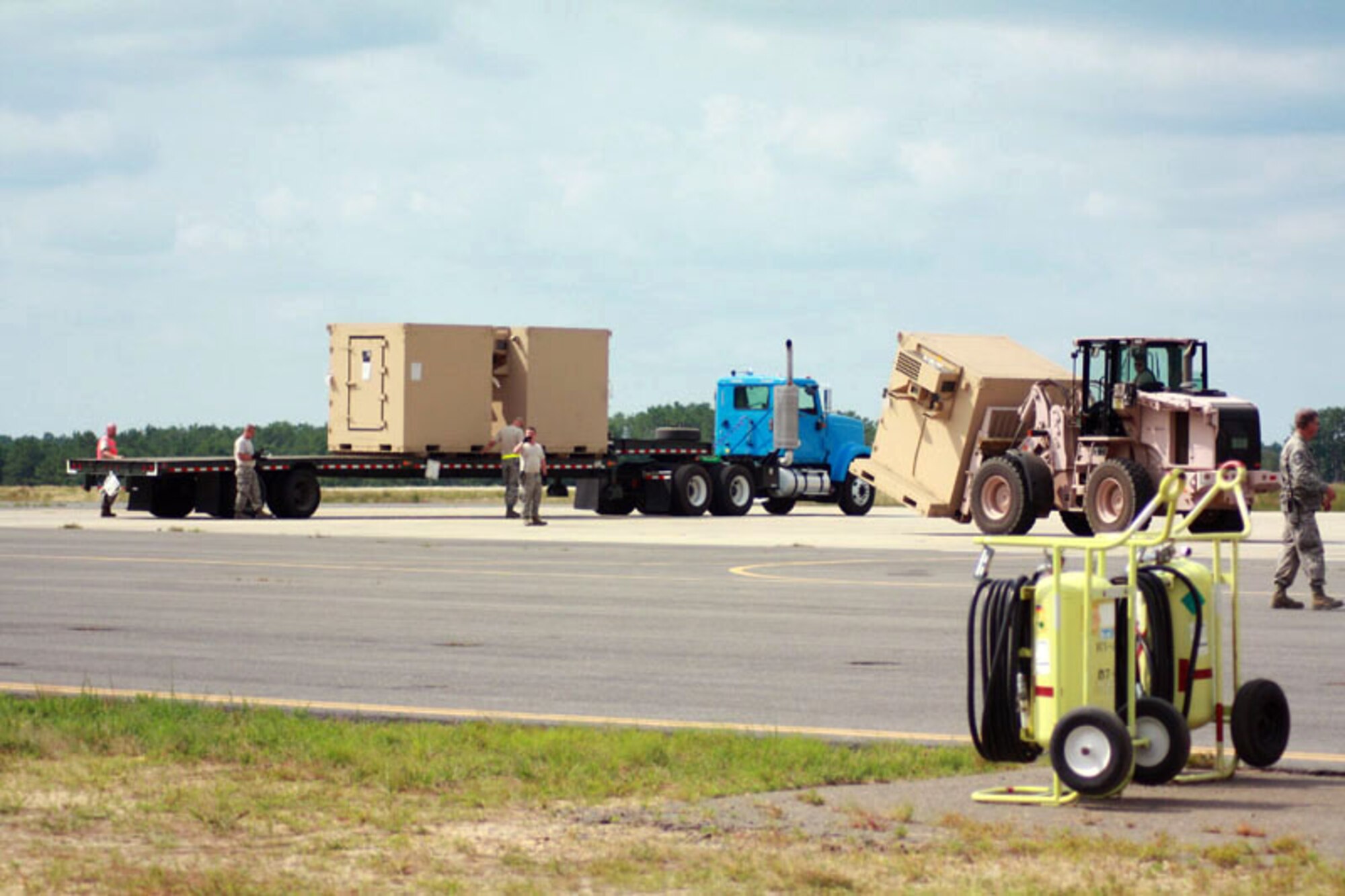 Soldiers and Airmen from exercise Eagle Flag offload pallets of food, water and shelter to be distributed July 27, 2010, to local villages in a simulated country needing humanitarian assistance at Joint Base McGuire-Dix-Lakehurst, N.J. (U.S. Air Force photo/Master Sgt. Phil Speck)