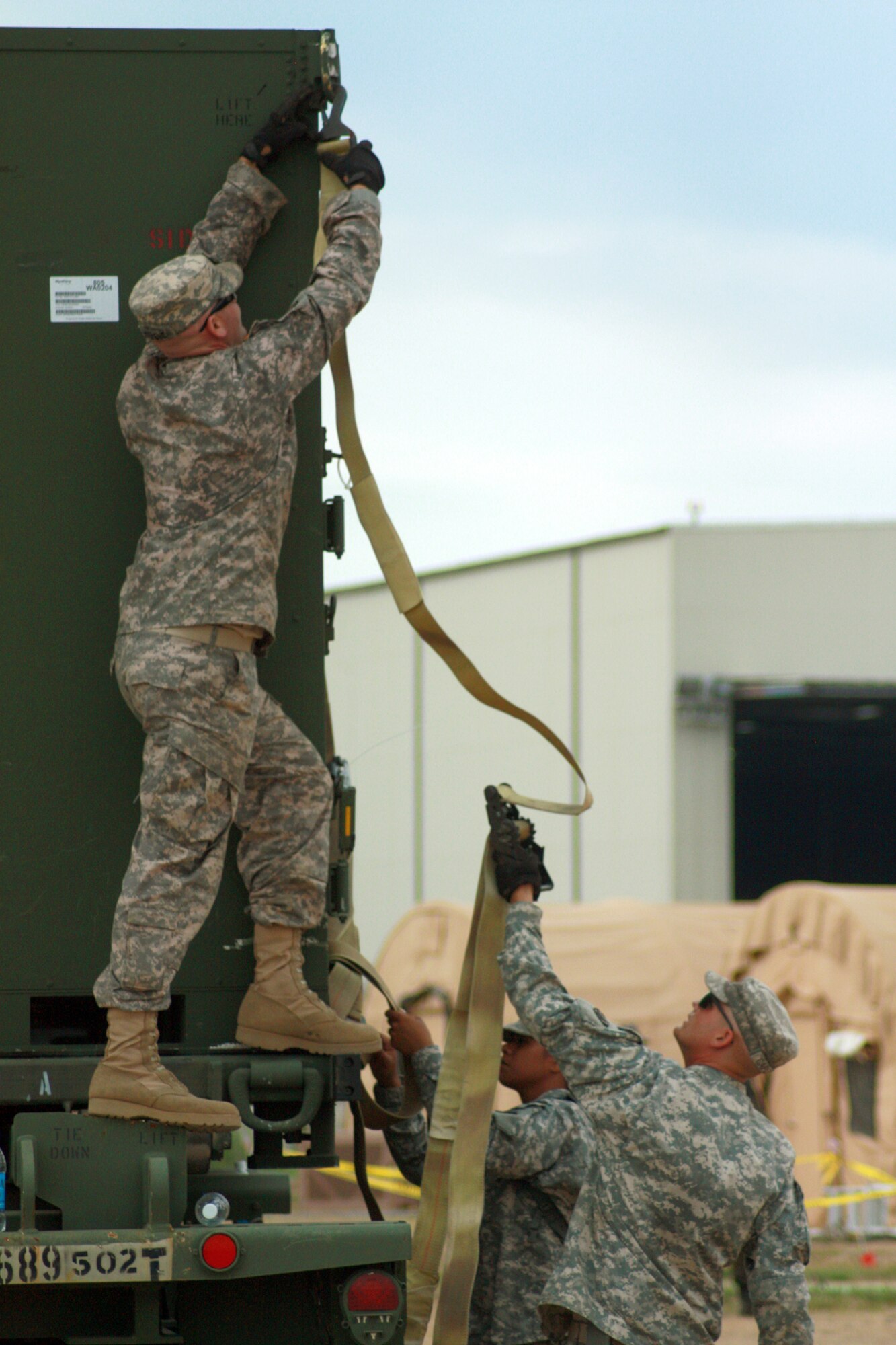 Soldiers of the 689th Rapid Port Opening Element load a pallet of food and water to be distributed to a simulated local village needing assistance during exercise Eagle Flag July 27, 2010, at Joint Base McGuire-Dix-Lakehurst, N.J. (U.S. Air Force photo/Master Sgt. Phil Speck)