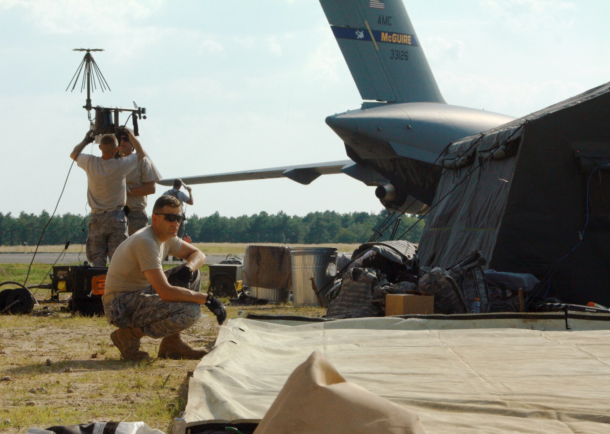 Chaplain (Lt. Col.) James Ehrman takes a quick break while assembling a tent after arriving July 27, 2010, at Joint Base McGuire-Dix-Lakehurst, N.J., to participate in joint exercise Eagle Flag, simulating humanitarian relief efforts in the fictional nation of "Nessor." Chaplain Ehrman is a member of the Kentucky Air National Guard's 123rd Contingency Response Group. (U.S. Army photo/Capt. Andi Hahn)