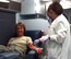 Blood drive coordinator SMSgt Tiyonna Evans prepares to donate blood at the Wing blood drive July 30.