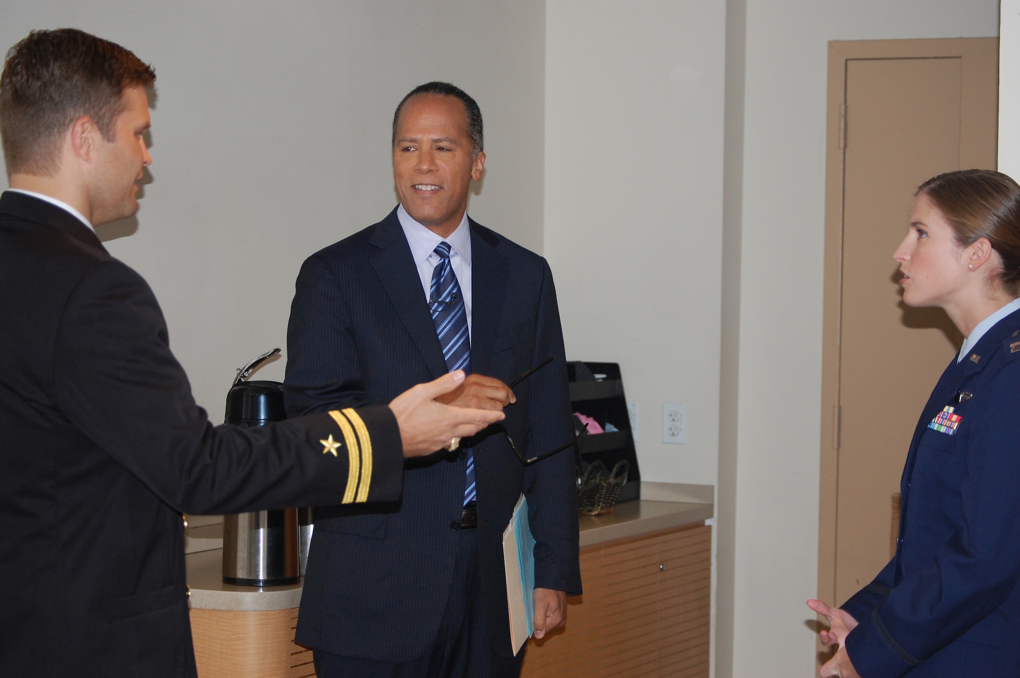 Lester Holt (center), weekend anchor for Today, talks with Lt. Jeff McLean and Capt. Christine McLean in the green room at NBC's studios prior to going live on-air. (USAF photo by Maj. Shannon Mann, 916ARW/PA)