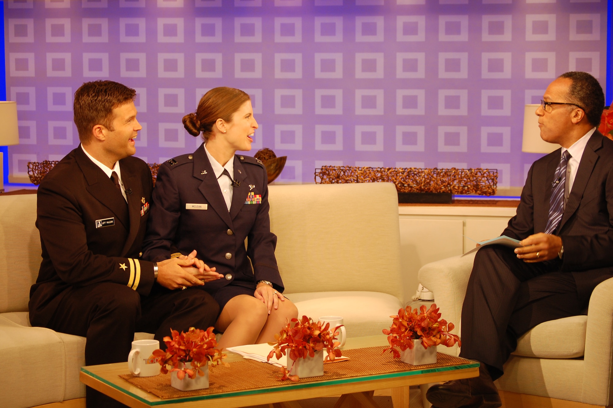 Navy Lt. Jeff McLean and wife, Air Force Capt. Christine McLean joke with NBC's Today weekend anchor Lester Holt prior to their live interview on Sunday, Aug. 1. (USAF photo by Maj. Shannon Mann, 916ARW/PA)