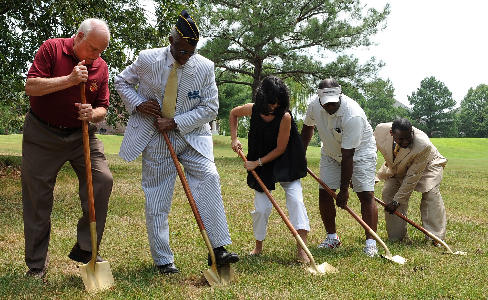 LANGLEY AIR FORCE BASE, Va. -- Julie Gentile (center), Christopher L. Brown, Disabled Veterans Committee on Housing director (far right), and others perform a ground breaking ceremony July 31. Army Lt. Col. (ret.) Earl Gentile, who is confined to a wheel chair due to multiple sclerosis, was helped by the Disabled Veterans Committee on Housing build a handicapped-access home. This organization helps disabled veterans receive grants up to $63,780 from the Department of Veterans Affairs to build, purchase or remodel their homes. (U.S. Air Force photo/ Senior Airman Gul Crockett)