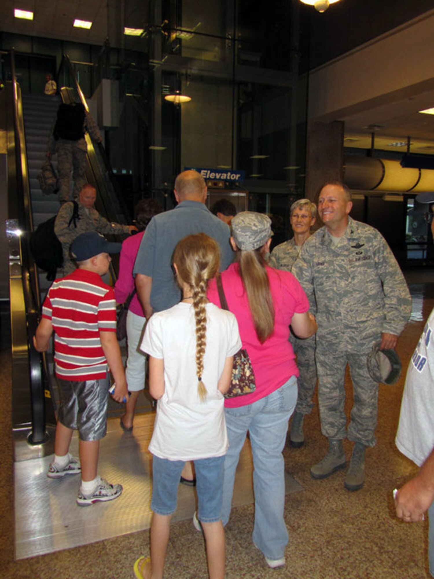 Col. Walter Sams, 419th Fighter Wing commander, and Senior Master Sgt. Cindy George, newly-appointed command chief, greet family members of wing civil engineer squadron personnel at the Salt Lake International Airport Saturday. Family and friends gathered at the airport to send off about 30 CES personnel departing for a six-month deployment to Afghanistan. (U.S. Air Force photo/Kari Tilton)
