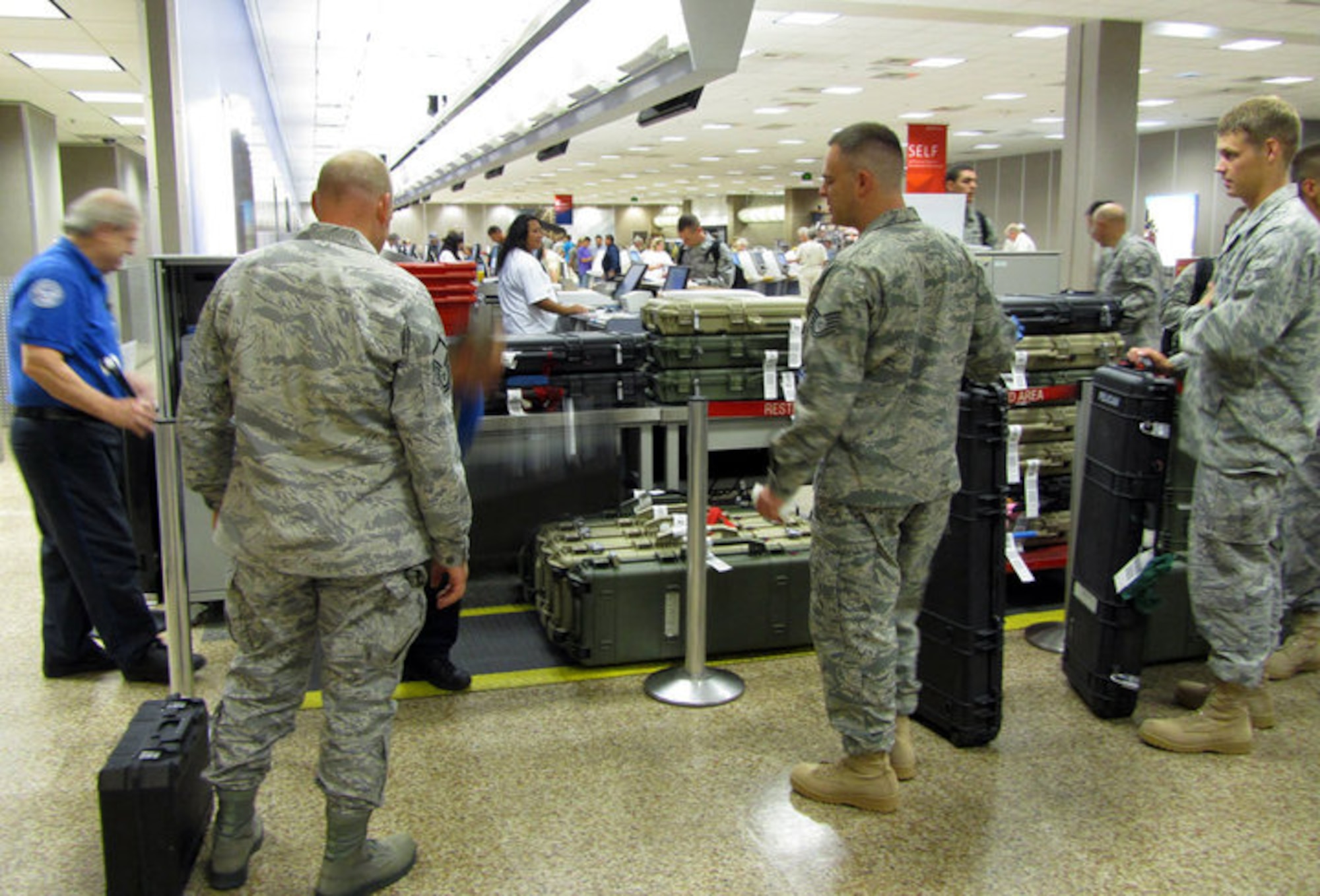 Several civil engineering personnel from the 419th Fighter Wing check in their weapons with airline security at the Salt Lake International Airport Saturday prior to their departure for a six-month deployment to Afghanistan.  (U.S. Air Force photo/Kari Tilton)