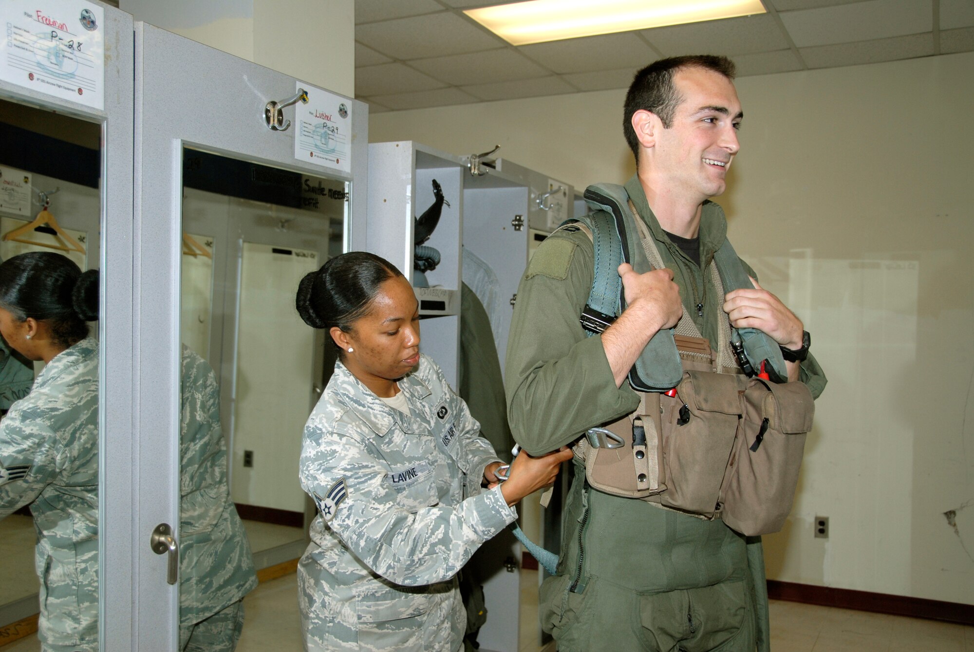 Senior Airman Anisah Lavine fits a torso harness for Capt. Michael Leary July 28, 2010, at Kunsan Air Base, South Korea. Members of the 35th and 80th Fighter Squadrons here flew a total of 20 sorties in support of exercise Invincible Spirit July 25 through 28, the first in a planned series of South Korean and U.S. Forces Korea combined naval exercises. Airman Lavine is an 8th Operations Support Squadron aircrew flight equipment technician. Captain Leary is a 35th Fighter Squadron pilot. (U.S. Air Force photo/Staff Sgt. Amanda Savannah)