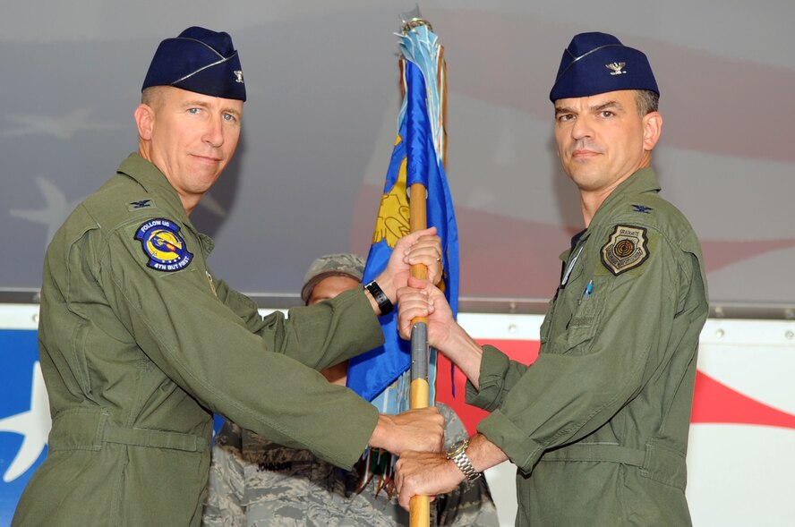 SEYMOUR JOHNSON AIR FORCE BASE, N.C. -- Col. Brian Kirkwood accepts command of the 4th Operations Group from Col. Patrick Doherty here July 30, 2010. Colonel Kirkwood is a master navigator with more than 3,400 flight hours including 660 combat hours. Colonel Doherty is the 4th Fighter Wing commander. (U.S. Air Force photo/Staff Sgt. Courtney Richardson)