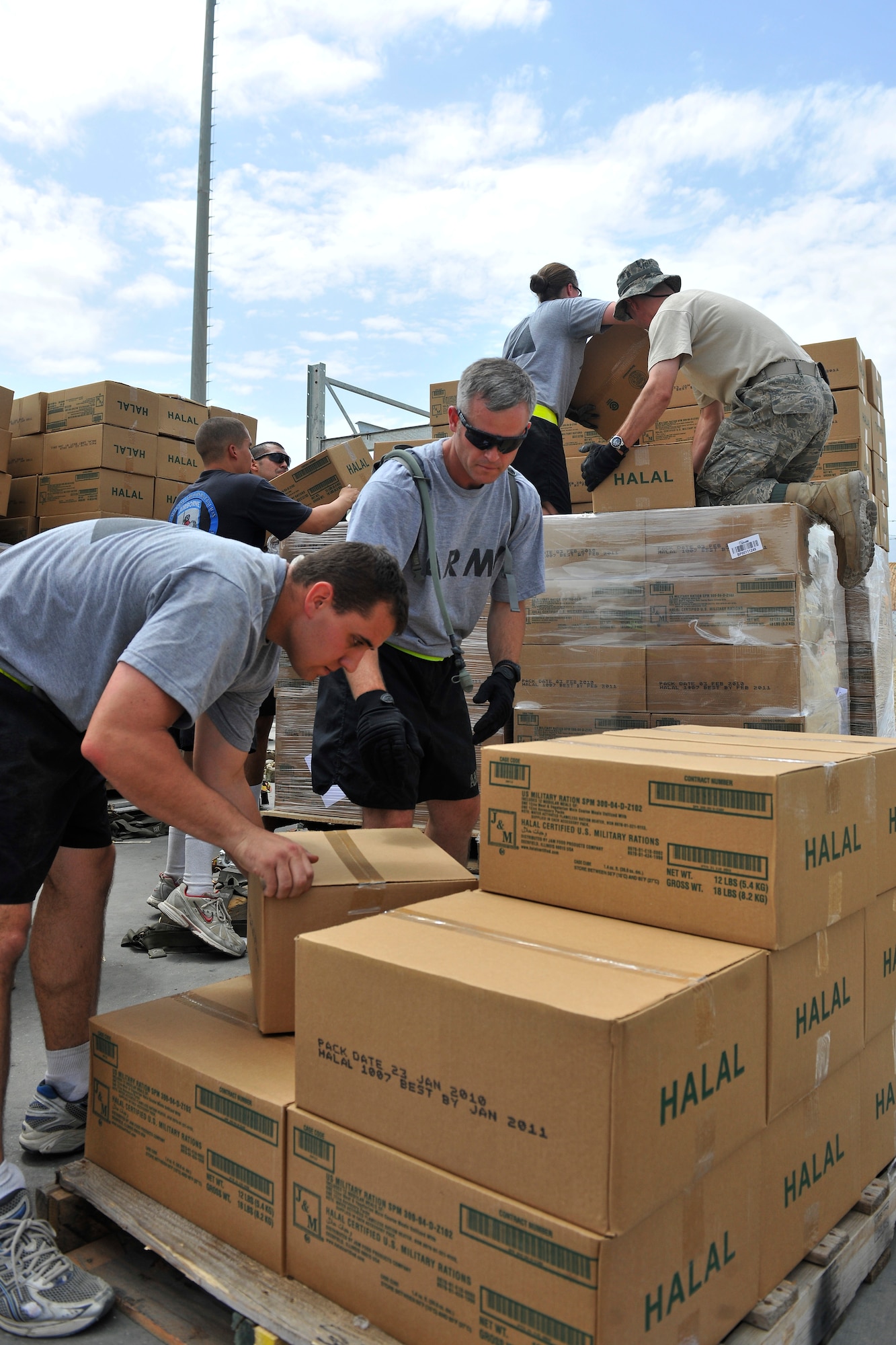 Airmen and Soldiers build pallets of Halal meals at Bagram Airfield, Afghanistan, Aug. 1, 2010. Floods in Pakistan have displaced hundreds of thousands and killed hundreds. Halal meals are prepared according to Islamic tradition. (U.S. Air Force photo/Staff Sgt. Christopher Boitz)