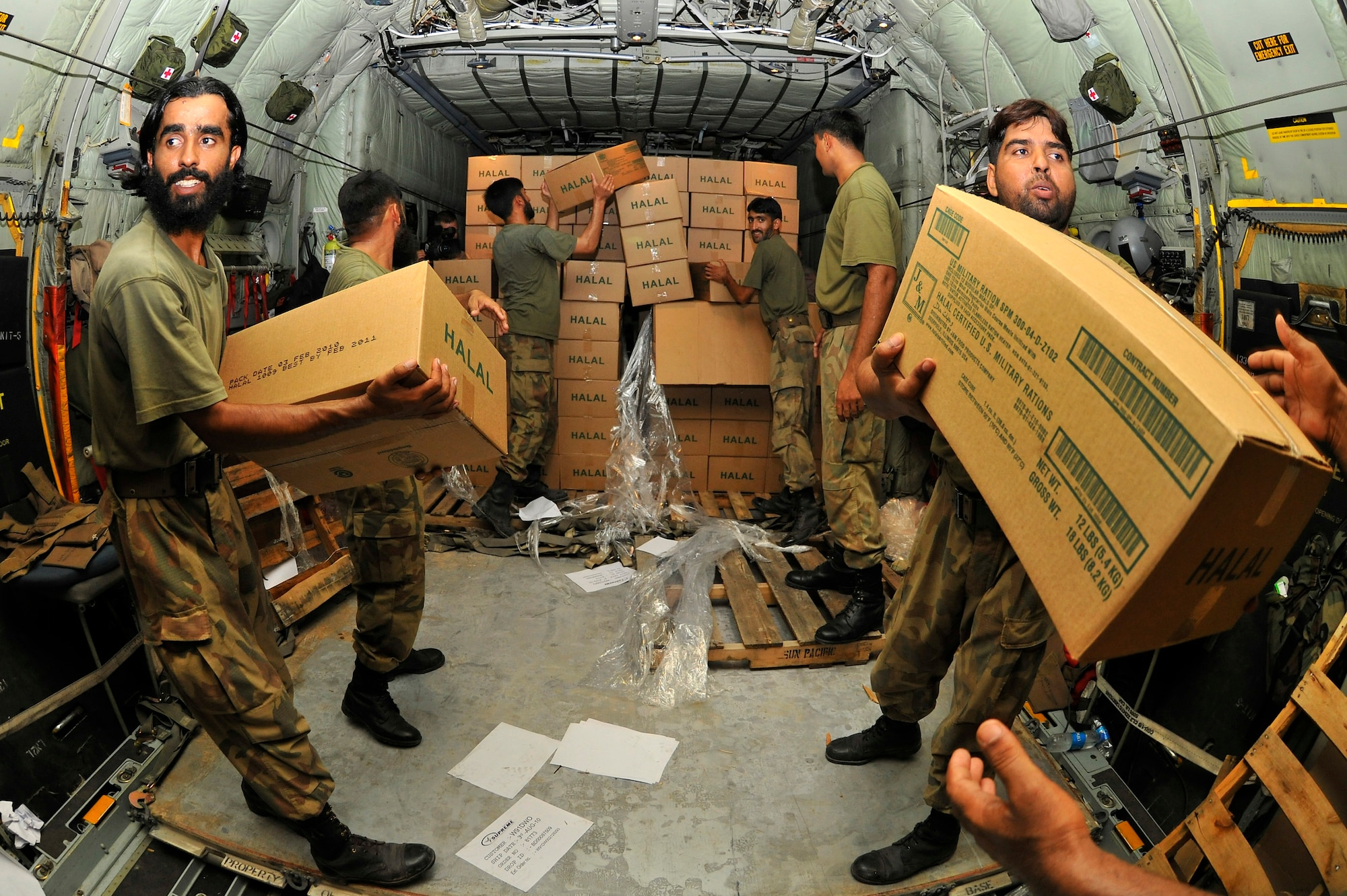 Pakistani Air Force members help unload thousands of Halal meals from a U.S. Air Force C-130H at Peshawar, Pakistan, Aug. 1, 2010. The meals will go to Pakistanis affected by the floods that have devastated the region. The C-130H is assigned to the 455th Air Expeditionary Wing at Bagram Airfield, Afghanistan. (U.S. Air Force photo/Staff Sgt. Christopher Boitz)