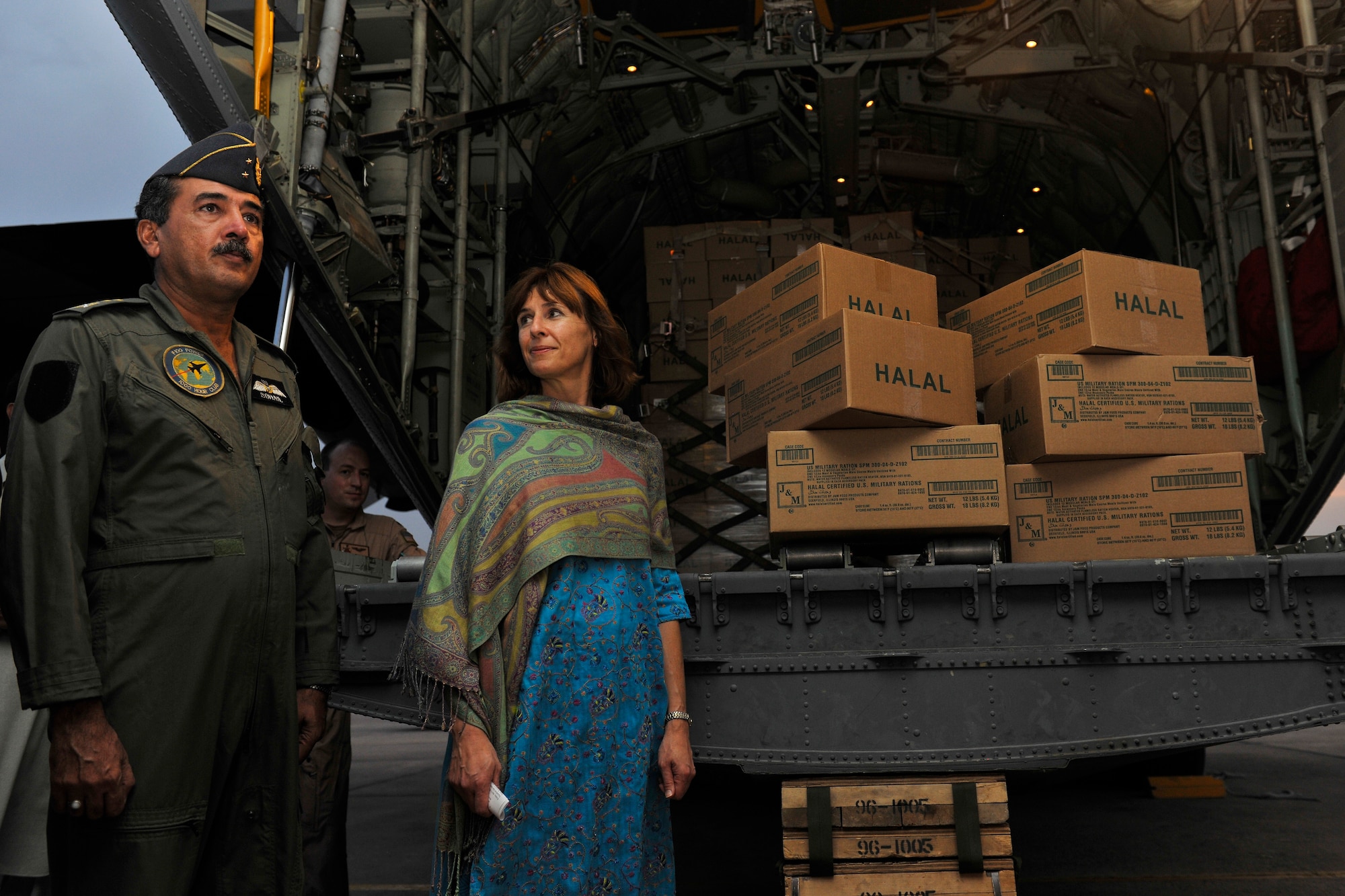 Maj. Gen. Sohail Shafkat, Air Officer Commanding for Northern Air Command in Pakistan, and Elizabeth Rood, Consul General at the U.S. Consulate General in Peshawar, stand next to thousands of Halal meals that were delivered by a C-130H assigned to the 455th Air Expeditionary Wing from Bagram Airfield, Afghanistan, Aug. 1, 2010. Floods Monsoon floods brought on by torrential rains have in Pakistan have devastated hundreds of thousands. (U.S. Air Force photo/Staff Sgt. Christopher Boitz)