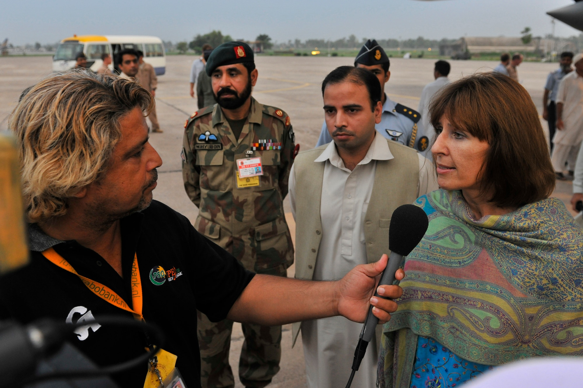 Pakistani news affiliates interview Elizabeth Rood, Consul General at the U.S. Consulate General in Peshawar, after a U.S. Air Force C-130H carrying thousands of Halal meals as part of a humanitarian relief mission landed at Peshawar, Pakistan, Aug. 1, 2010. Monsoon floods brought on by torrential rains have in Pakistan have devastated hundreds of thousands.  The C-130H is assigned to the 455th Air Expeditionary Wing at Bagram Airfield, Afghanistan. (U.S. Air Force photo/Staff Sgt. Christopher Boitz)