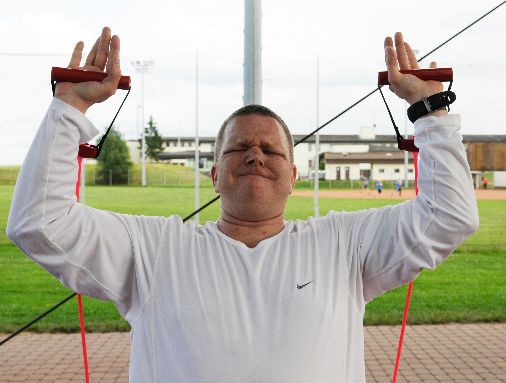 SPANGDAHLEM AIR BASE, Germany – Tech. Sgt. Terry Little, 606th Air Control Squadron, performs a set of overhead presses during his workout with the Intrepid Fitness Boot Camp on the outdoor basketball court June 14. Intrepid Fitness is a six-week fitness program created and operated by two members of the Spangdahlem community. (U.S. Air Force photo/ Staff Sgt. Benjamin Wilson)