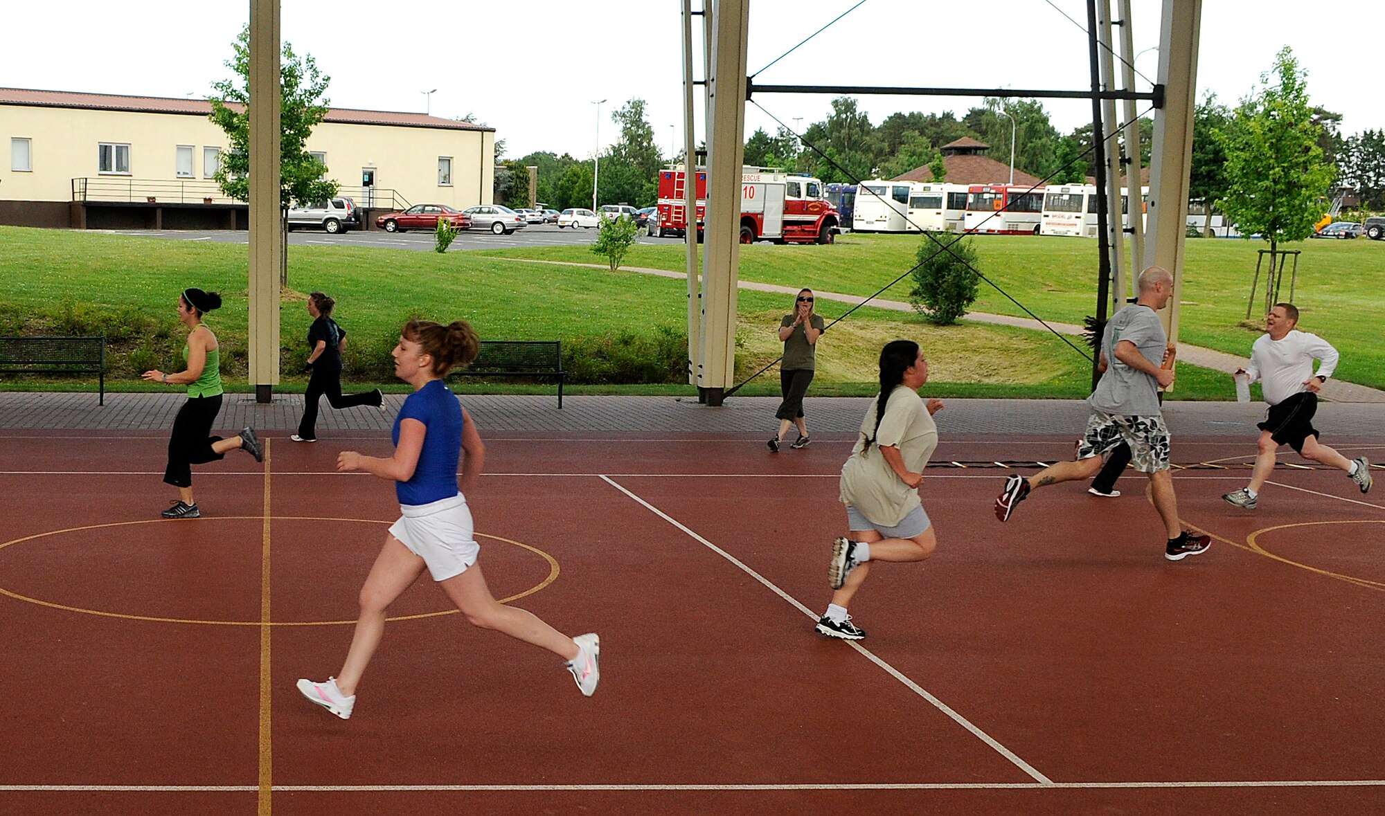 SPANGDAHLEM AIR BASE, Germany – Participants in the Intrepid Fitness Boot Camp sprint between obstacles during their workout on the outdoor basketball court June 14. The fitness program, created by two Air Force spouses, is a circuit training-style workout held three times a week. (U.S. Air Force photo/ Staff Sgt. Benjamin Wilson)