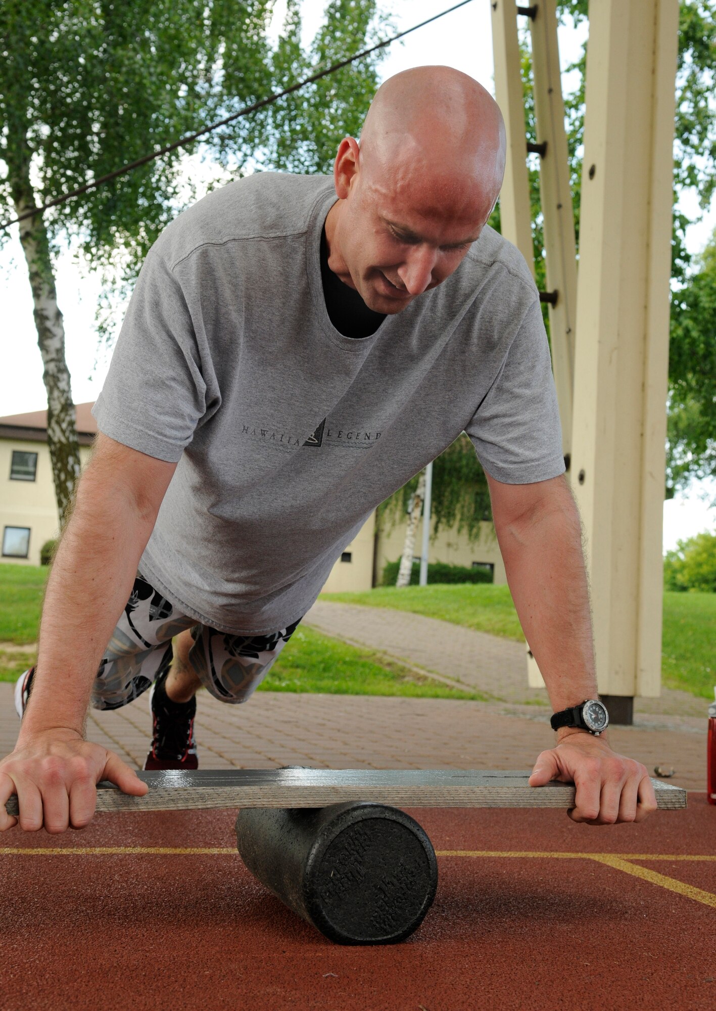 SPANGDAHLEM AIR BASE, Germany – Tech. Sgt. Scott Haxby, 52nd Medical Operations Squadron, performs push-ups on a balance bar while participating in the Intrepid Fitness Boot Camp on the outdoor basketball court June 14. Intrepid Fitness is a six-week fitness created and operated by two members of the Spangdahlem community. (U.S. Air Force photo/Staff Sgt. Benjamin Wilson)
