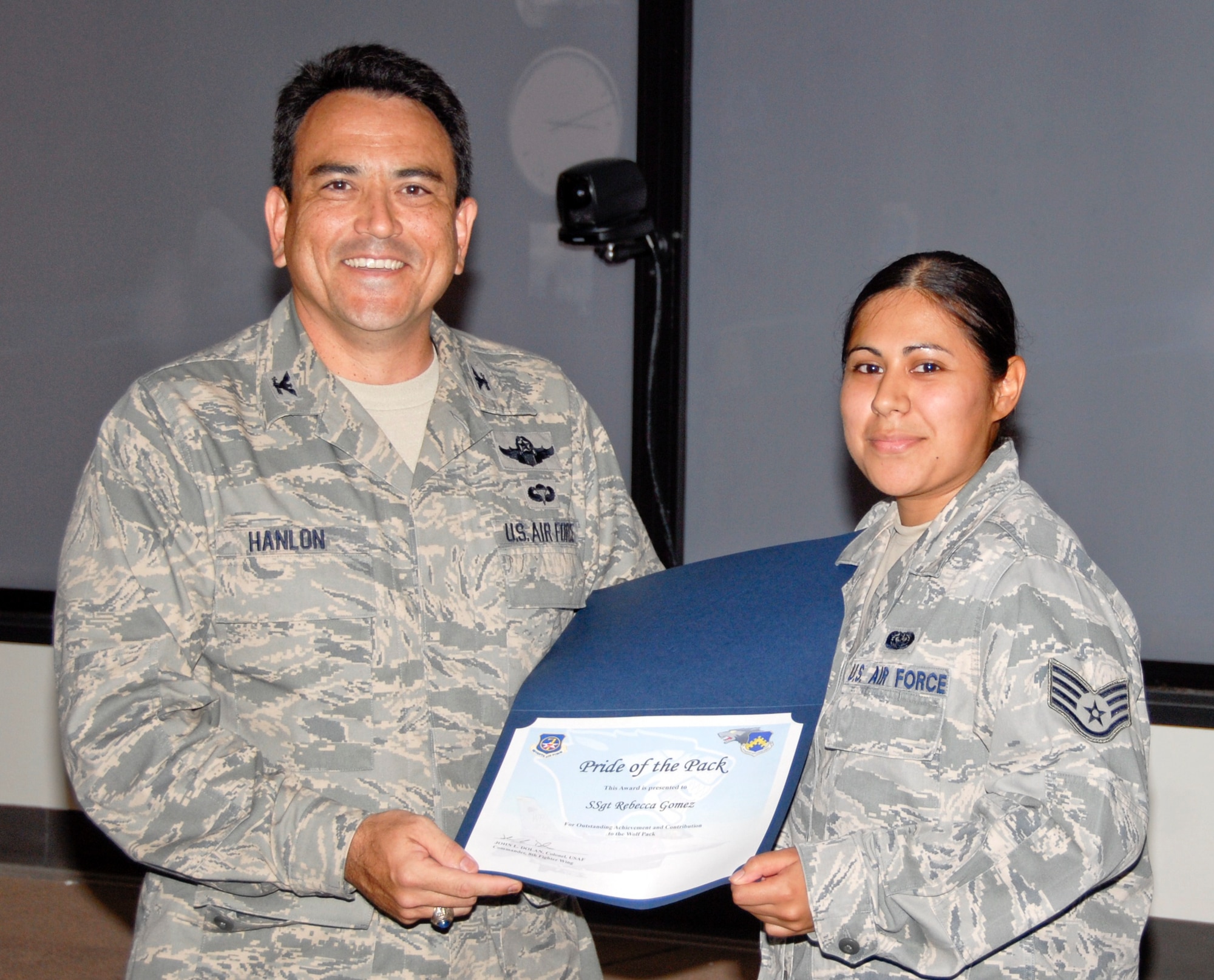 KUNSAN AIR BASE, Republic of Korea -- Col. Hugh Hanlon, 8th Fighter Wing vice commander, presents Staff Sgt. Rebecca Gomez, 8th FW client support technician, with a Pride of the Pack award July 29. (U.S. Air Force photo/Capt. Sheryll Klinkel)