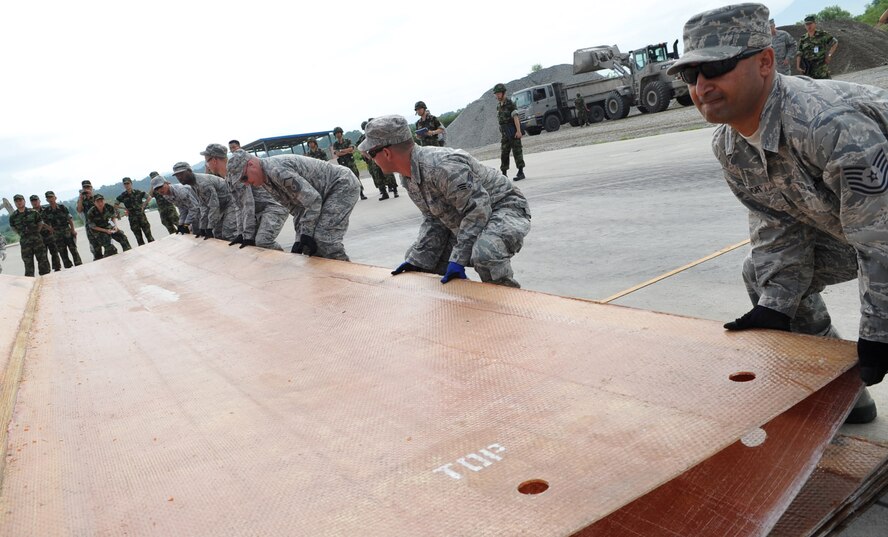 Tech. Sergeant Yuvraj Singh, 51st Civil Engineer Squadron, helps unfold a fiberglass mat during the 2010 Combined Airfield Repair Exercise at Jungwon AB, July 29.  The purpose of the exercise was to enhance interoperability, evaluate capabilities, and strengthen combined relationships with Republic of Korea Air Force members. (U.S. Air Force Photo/Senior Airman Evelyn Chavez)
