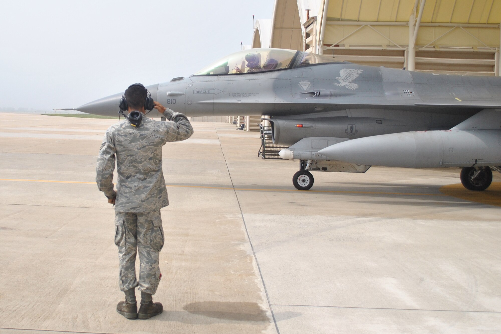 KUNSAN AIR BASE, South Korea -- Airman 1st Class Hector Arroyo, 14th Aircraft Maintenance Unit crew chief, launches an F-16 Fighting Falcon June 15 on the flightline. Airman Arroyo and his unit, along with members of the 14th Fighter Squadron, are deployed to Kunsan Air Base in an effort to maintain regional stability in the Asia-Pacific theater and promote stronger relations with U.S. allies. (courtesy photo by Tech. Sgt. Michael Nelson)