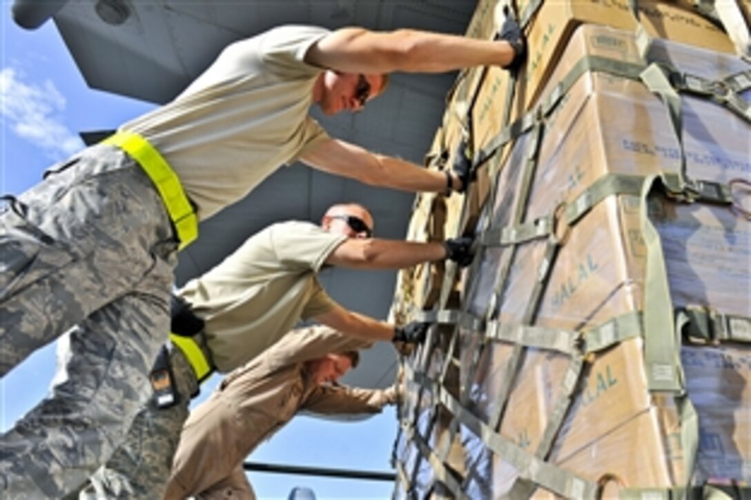 U.S. Air Force airmen push pallets of halal meals onto a C-130H aircraft at Bagram Airfield, Afghanistan, Aug. 1, 2010. The humanitarian aid meals, prepared according to Islamic tradition, will be delivered to Pakistan as part of a humanitarian relief mission. Monsoon floods brought on by torrential rains have devastated hundreds of thousands in Pakistan. The aircrew, assigned to the 455th Air Expeditionary Wing, is part of an Air National Guard Unit deployed from Peoria, Ill.