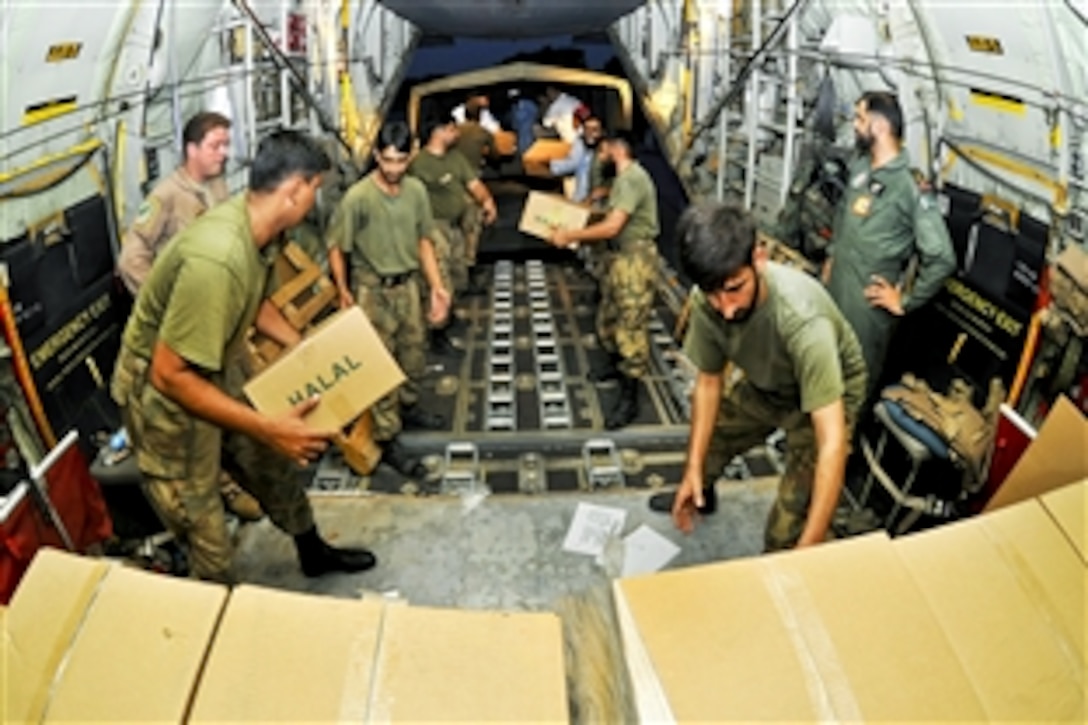 Pakistani Air Force airmen help unload thousands of halal meals from a U.S. Air Force C-130H aircraft in Peshawar, Pakistan, Aug. 1, 2010. The meals, prepared according to Islamic law, will go to Pakistanis affected by the floods that have devastated the region. The C-130H is assigned to the 455th Air Expeditionary Wing on Bagram Airfield, Afghanistan. 