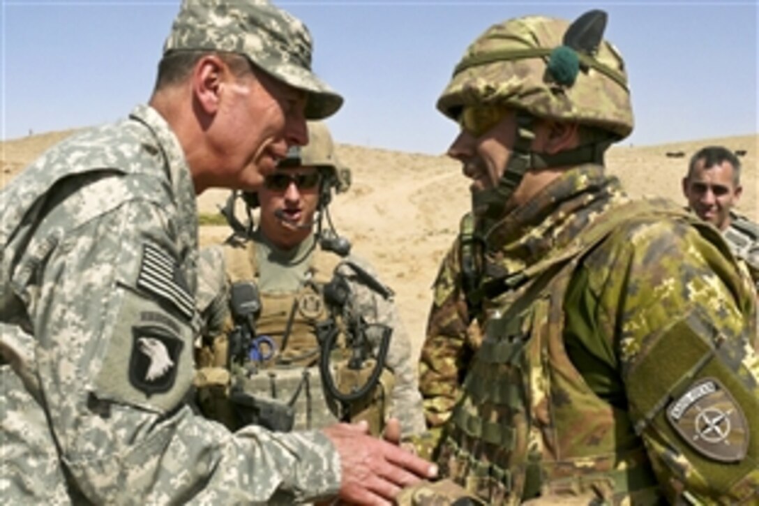 U.S. Army Gen. David H. Petraeus, commander of the International Security Assistance Force, speaks with Col. Massimo Biagini, commander of the Italian Task Force North, in Bala Morghab, Afghanistan, Aug. 2, 2010. Petraeus visited Afghan and coalition troops deployed in Qal’ah-Ye Now, Moqur and Bala Morghab in Badghis province in the Regional Command West’s area of operations. 