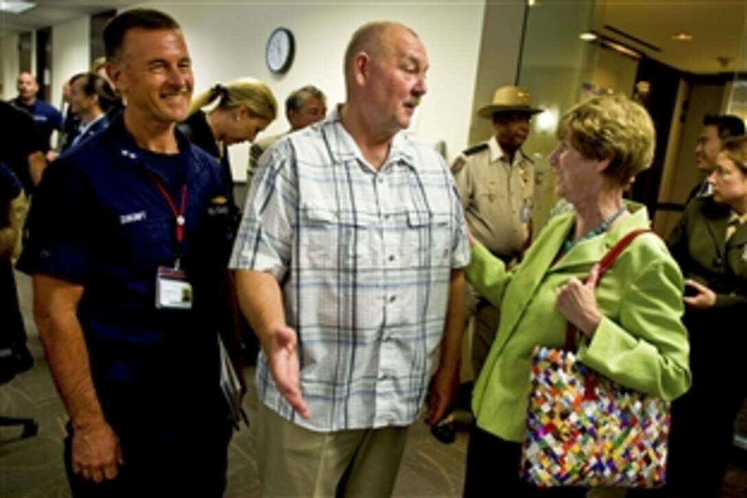 Deborah Mullen speaks with Retired Coast Guard Adm. Thad Allen, the national incident commander for the Gulf oil spill, and Coast Guard Rear Adm. Paul Zukunft, assistant commandant for marine safety, security and stewardship, at the Deepwater Horizon Unified Command Center in New Orleans, Aug. 2, 2010. Mullen is the wife of Navy Adm. Mike Mullen, chairman of the Joint Chiefs of Staff.