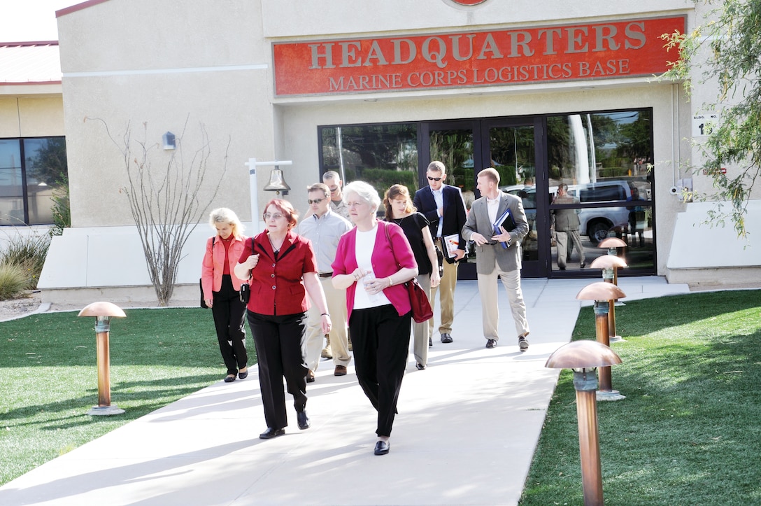 Margaret Carter(front left), Executive Officer, Marine Corps Logistic Base Barstow, Calif., leads House Armed Service Committee Professional Staff members; Vickie Plunkett (right), Cathy Garmen, Jack Shuler, Lynn Williams, Marine Corps Congressional Liaison Officer Maj. Jonathan Schnieder, Army Liaison Officer Maj. Dave Evans and Base Commanding Officer Col. Daniel Ermer to a vehicle for a windshield tour of Nebo and then to Maintenance Center Barstow for a command brief and tour of that facility, Aug. 6.  the delegation visited the installation to learn more about MCLB Barstow's joint operations and how the base is strategically and uniquely poised to conduct multiple integrated missions. The staff members requested a "walk and talk" tour for a ground-level understanding of Marine Corps reconstitution/reset/recapitalization efforts and how the base missions relate to Marine Corps and Department of Defense readiness and civilian work force planning.