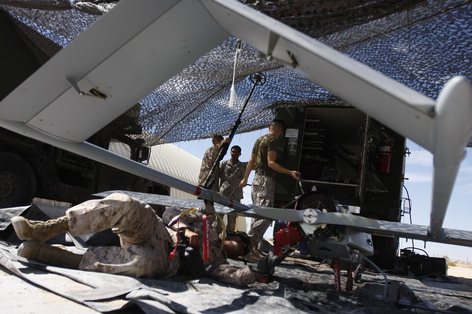 Marine Unmanned Aerial Vehicle Squadron 3 mechanics work on an RQ-7B UAV at the Combat Center's Expeditionary Air Field Aug. 3.  The technicians are a small piece of the puzzle when it comes to a UAV mission in support of ground troops.