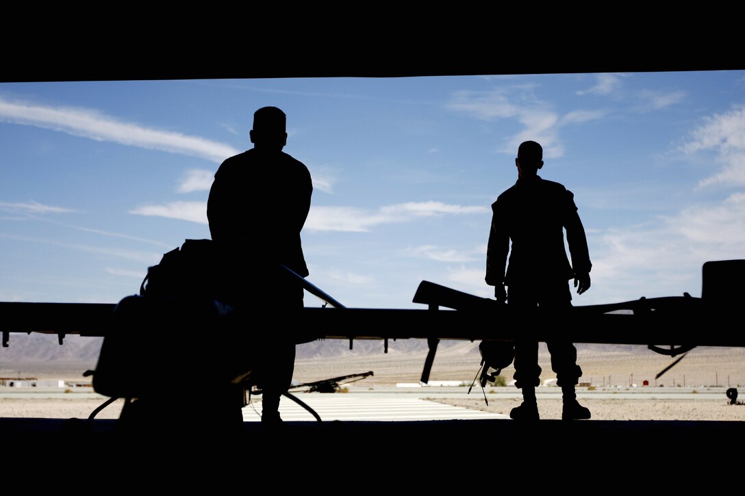 Unmanned aerial vehicle mechanics with Marine Unmanned Aerial Vehicle Squadron 3 wheel out an RQ-7B UAV to do pre-flight checks on the systems before one of their flight operations in support of Enhanced Mojave Viper at the Combat Center's Expeditionary Air Field Aug. 3.