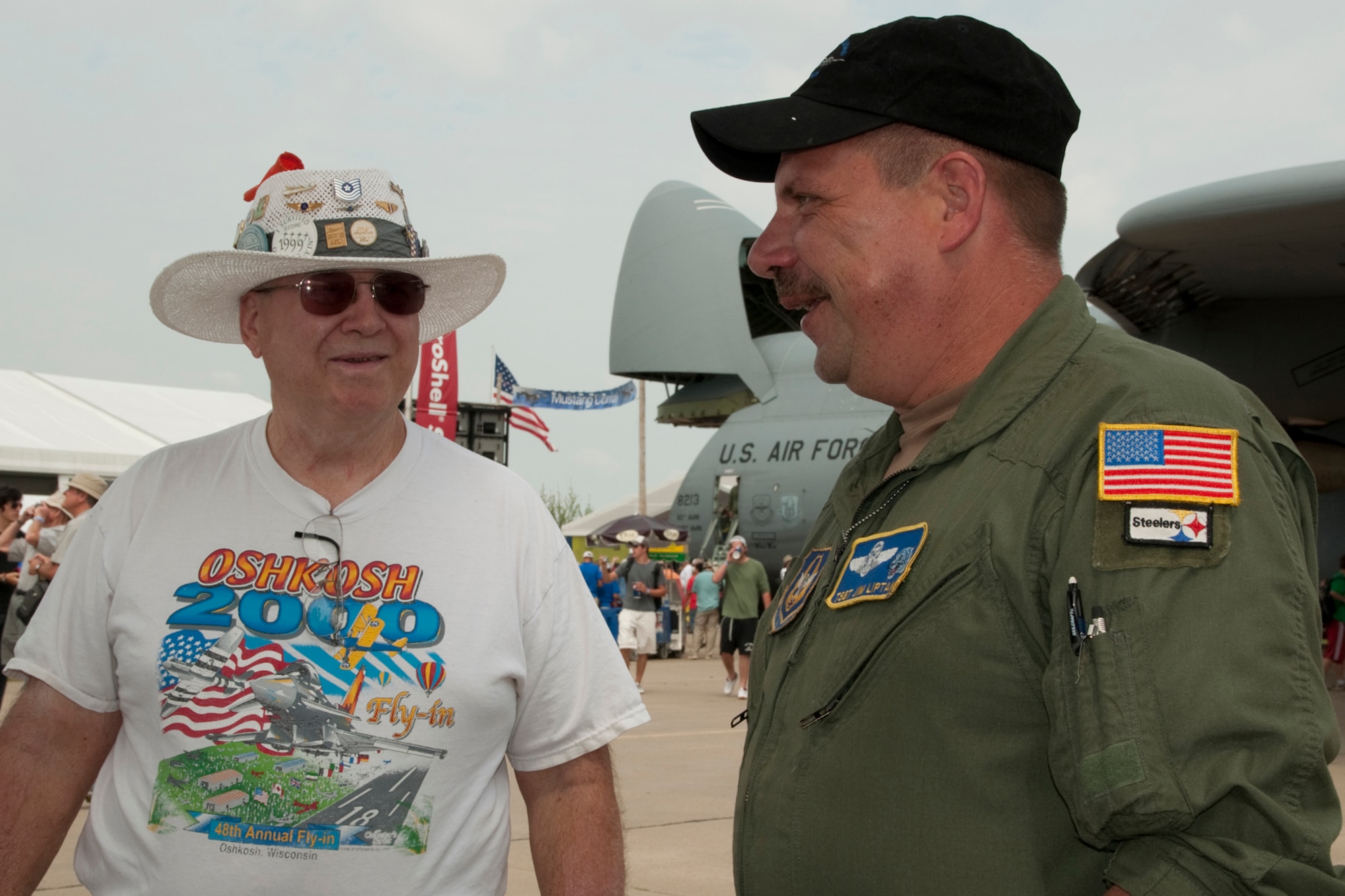 OSHKOSH, Wis. -- Tech. Sgt. James Liptak, flight engineer with the 757th Airlift Squadron based Youngstown Air Reserve Station, Ohio, speaks with an AirVenture 2010 air show spectator in front of a YARS specially-equipped aerial spray C-130H at Wittman Regional Airport here, July 30, 2010. This aircraft and approximately 14 YARS Airmen were invited to particpate in this air show because of their recent involvement in the Gulf oil spill relief efforts. The 910th AW is home to the Department of Defense's only large area fixed-wing aerial spray mission. U.S. Air Force photo by Senior Airman Brenda Haines