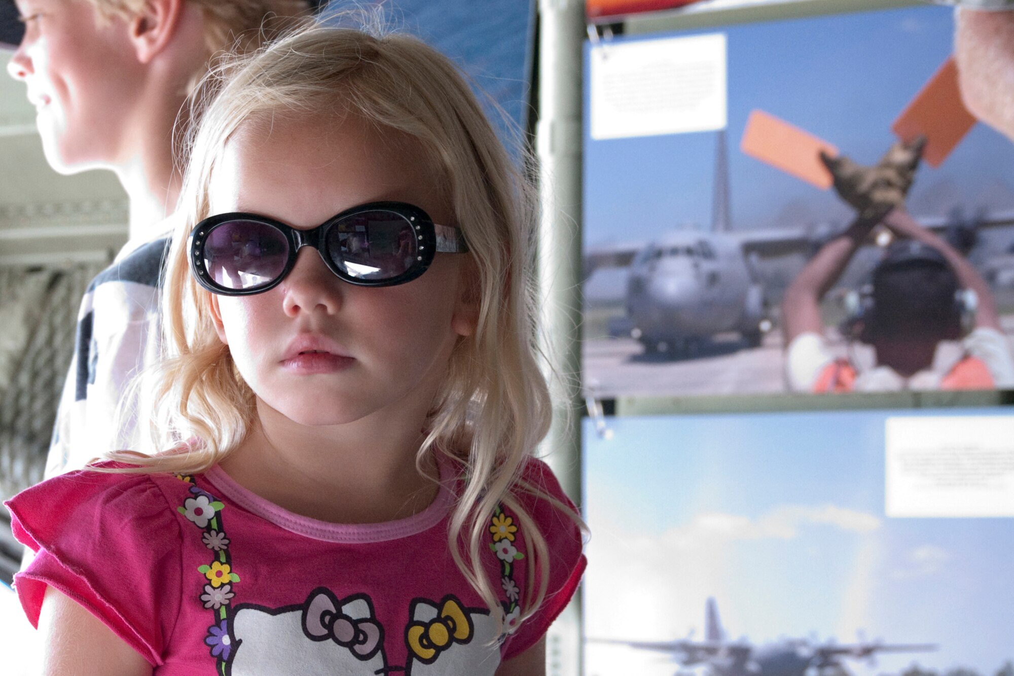 OSHKOSH, Wis. -- A young air show spectator examines a U.S. Air Force specially-equipped aerial spray C-130H aircraft from the 910th Airift Wing based at Youngstown Air Reserve Station, Ohio, while it is on display at Wittman Regional Airport here, July 30, 2010. This aircraft and approximately 14 YARS Airmen were invited to particpate in this air show because of their recent involvement in the Gulf oil spill relief efforts. The 910th AW is home to the Department of Defense's only large area fixed-wing aerial spray mission. U.S. Air Force photo by Senior Airman Brenda Haines