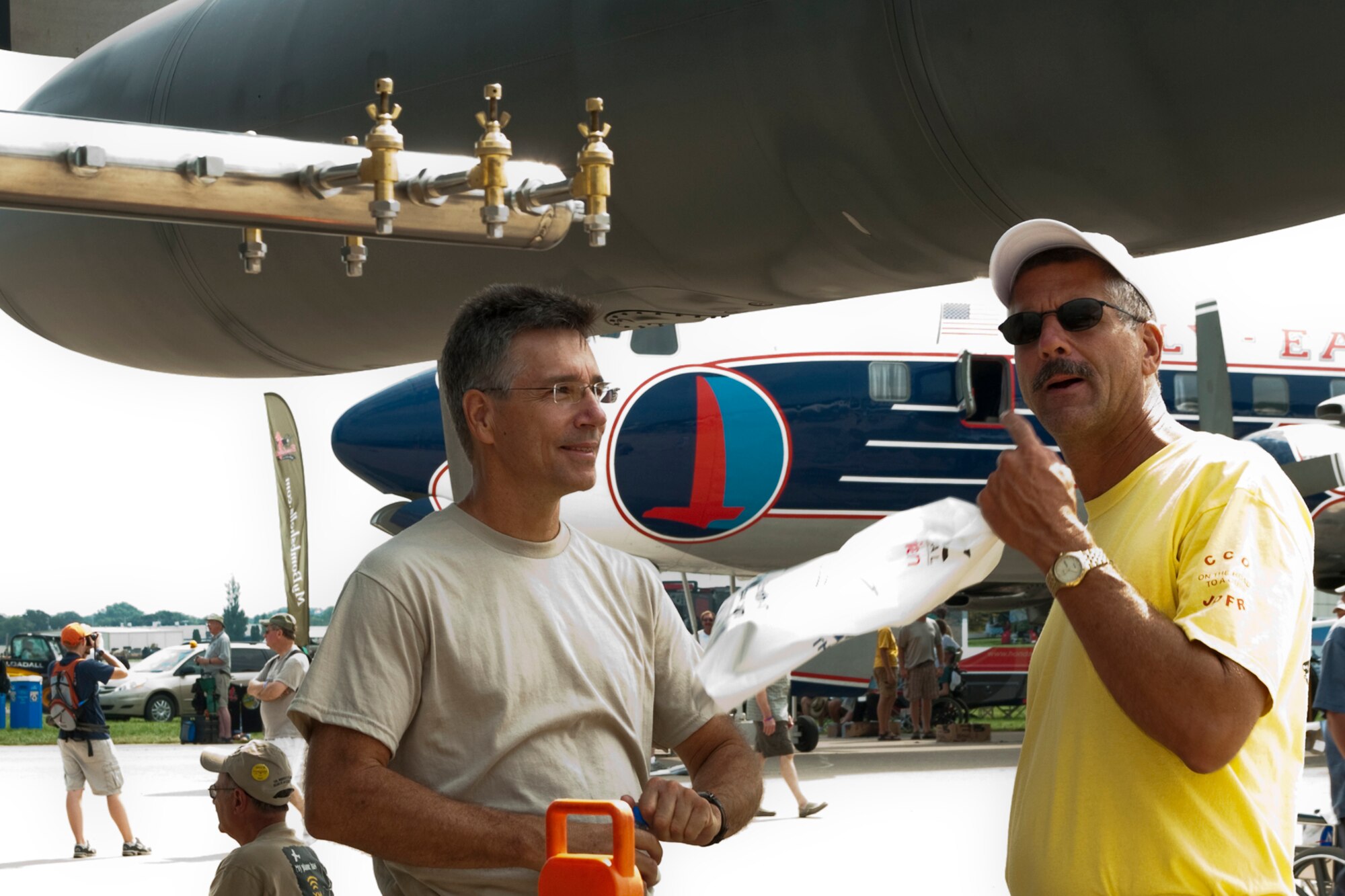 OSHKOSH, Wis. -- Master Sgt. Jeffrey Roach, an aerospace propulsion technician with the 910th Maintenance Squadron based Youngstown Air Reserve Station, Ohio, speaks with an AirVenture 2010 air show spectator at Wittman Regional Airport here, July 30, 2010. This aircraft and approximately 14 YARS Airmen were invited to particpate in this air show because of their recent involvement in the Gulf oil spill relief efforts. The 910th AW is home to the Department of Defense's only large area fixed-wing aerial spray mission. U.S. Air Force photo by Senior Airman Brenda Haines