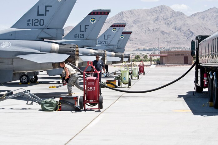 NELLIS AIR FORCE BASE, Nev. -- Senior Airman Brett Arsenault, fuels specialist, 9th Logistics Readiness Squadron, Beale, AFB Calif, refuels a squadron of F-16CG aircraft belonging to the Republic of Singapore Air Force (RSAF), on the Nellis flight line, July 29, 2010 after the aircraft returned from a Red Flag 10-4 exercise training mission.  The 99th Logistics Readiness Squadron, Fuels Management Flight issued over 3.5 million gallons of JP-8 fuel to over 70 aircraft during the two week exercise.  (U.S. Air Force photo/Lawrence Crespo)
 





