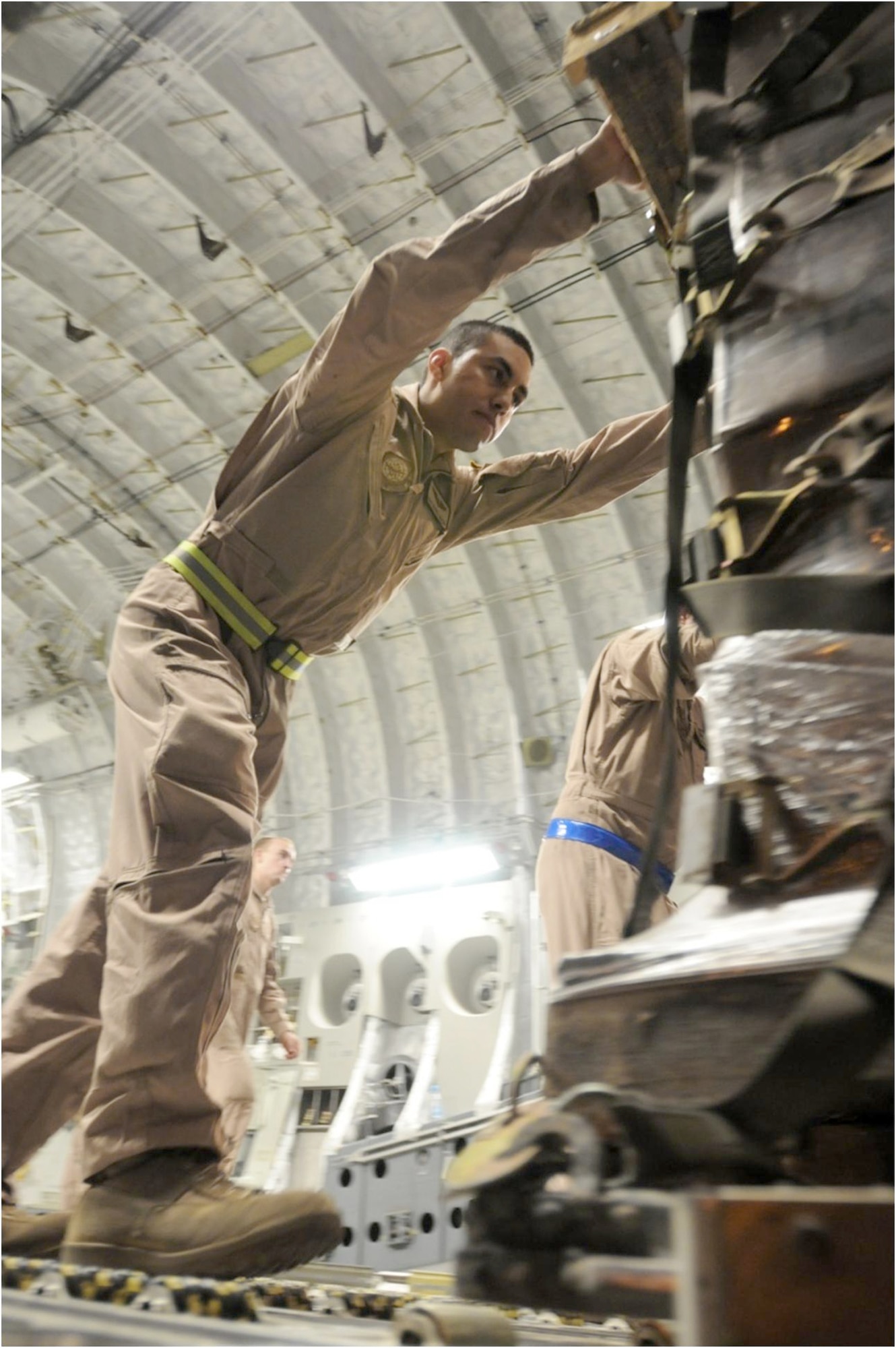 Staff Sgt. Manuel Chacon pushes a pallet of halal meals off a C-17 Globemaster III that carried them Aug. 2, 2010, to northwestern Pakistan. These meals are some of the 345 thousand that have been delivered since July 31, 2010, as part of the humanitarian flood relief assistance provided to the area that's been hit by monsoon rains in recent days. Sergeant Chacon is a loadmaster assigned to the 817th Expeditionary Airlift Squadron at the Transit Center at Manas, Kyrgyzstan. (U.S. Air Force photo/Capt. Chris Sukach)