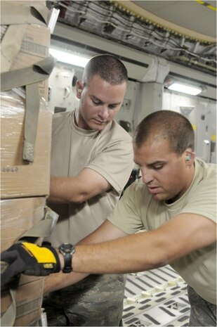 Tech. Sgts. Gregory Boshears and Kevin Paridee load a pallet of halal meals onto a C-17 Globemaster III Aug. 2, 2010, at Bagram Airfield, Afghanistan, for transportation into the flood-stricken areas of northwest Pakistan. Sergeants Boshears and Paridee are members of the 455th Aerial Port Squadron. (U.S. Air Force photo/Capt. Chris Sukach)