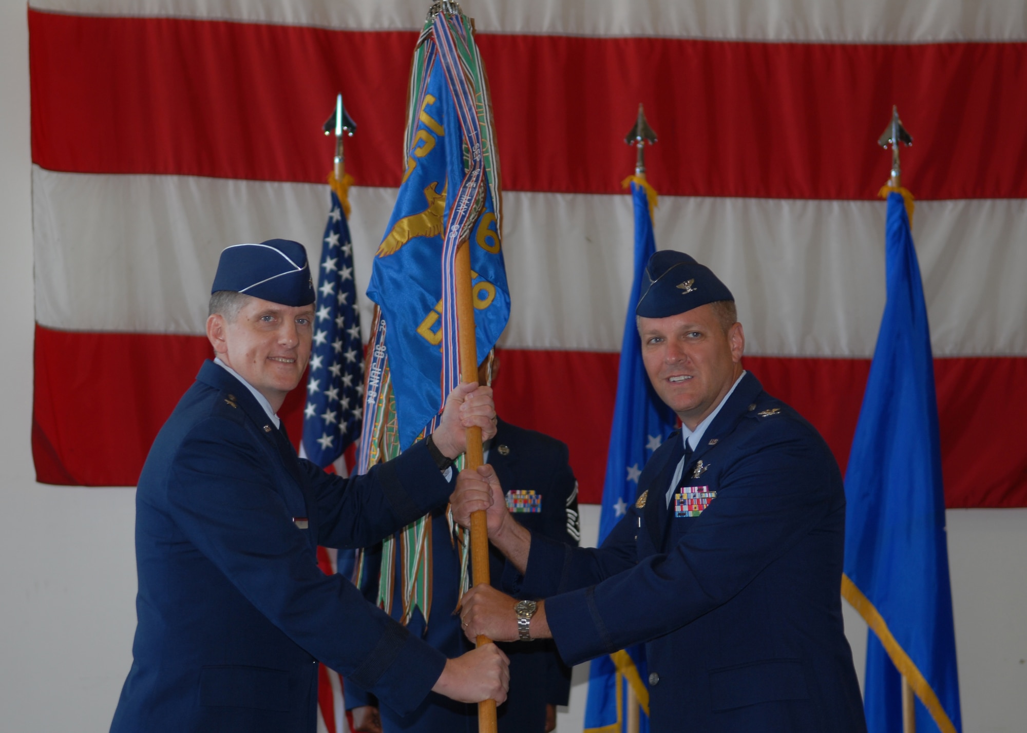 VANDENBERG AIR FORCE BASE, Calif. - Col. David Bliesner, the incoming 576th Flight Test Squadron commander, assumes command as he accepts the guidon flag from Brig. Gen. Timothy Ray, the Director of Operations, Headquarters Air Force Global Strike Command, during a change of command ceremony here Monday, Aug. 2, 2010. (U.S. Air Force photo/Senior Airman Antoinette Gibson)