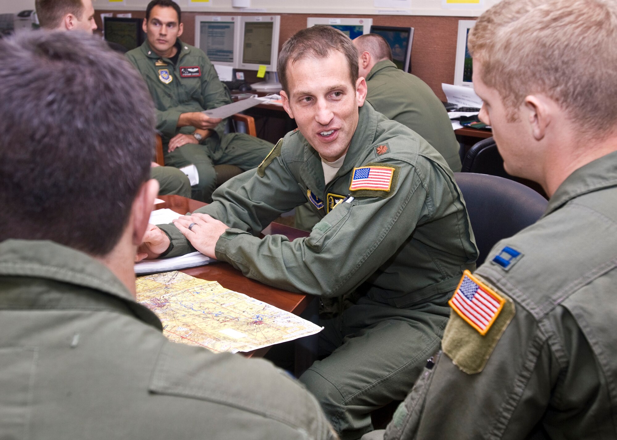 Maj. James O'Brien (center), 48th Airlift Squadron scheduling flight commander, instructs student pilots on pilot techniques for low-level time over target control and threat avoidance. Major O'Brien was presented the Gen. Benjamin O. Davis Jr. Military Award for excellence in professional and community service. (U.S. Air Force photo by Staff Sgt. Nestor Cruz)