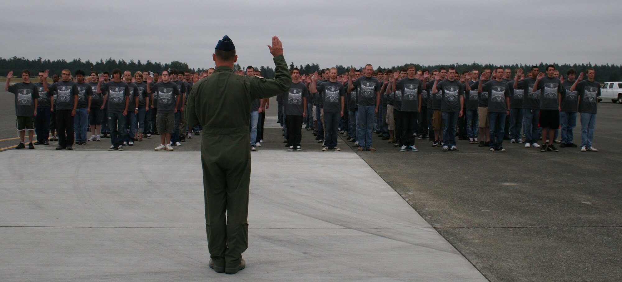 Col. Kevin Kilb, commander of the 62nd Airlift Wing at Joint Base Lewis McChord, Wash., swears in more than 200 future Airmen at a Delayed Enlistment Program (DEP) ceremony  at the McChord Air Expo July 14. The number of participants (201) was a record number for the Air Force, according to officials from the 361st Recruiting Squadron. (U.S. Air Force photo/Christine Lang)