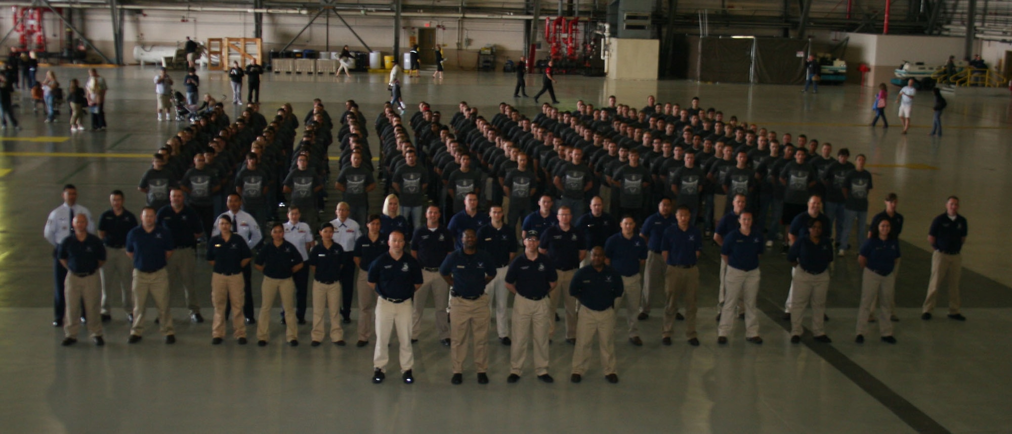 Two hundred and one future Airmen stand in formation with Air Force Recruiting Service personnel from the 361st Recruiting Squadron before a Delayed Enlistment Program (DEP) swearing-in ceremony at Joint Base Lewis McChord, Wash. The previous enlistment record for the Air Force was 178, according to 361st RCS officials. The ceremony took place at the McChord Air Expo July 14. Col. Kevin Kilb, commander of the 62nd Airlift Wing, officiated. (U.S. Air Force photo/Christine Lang)