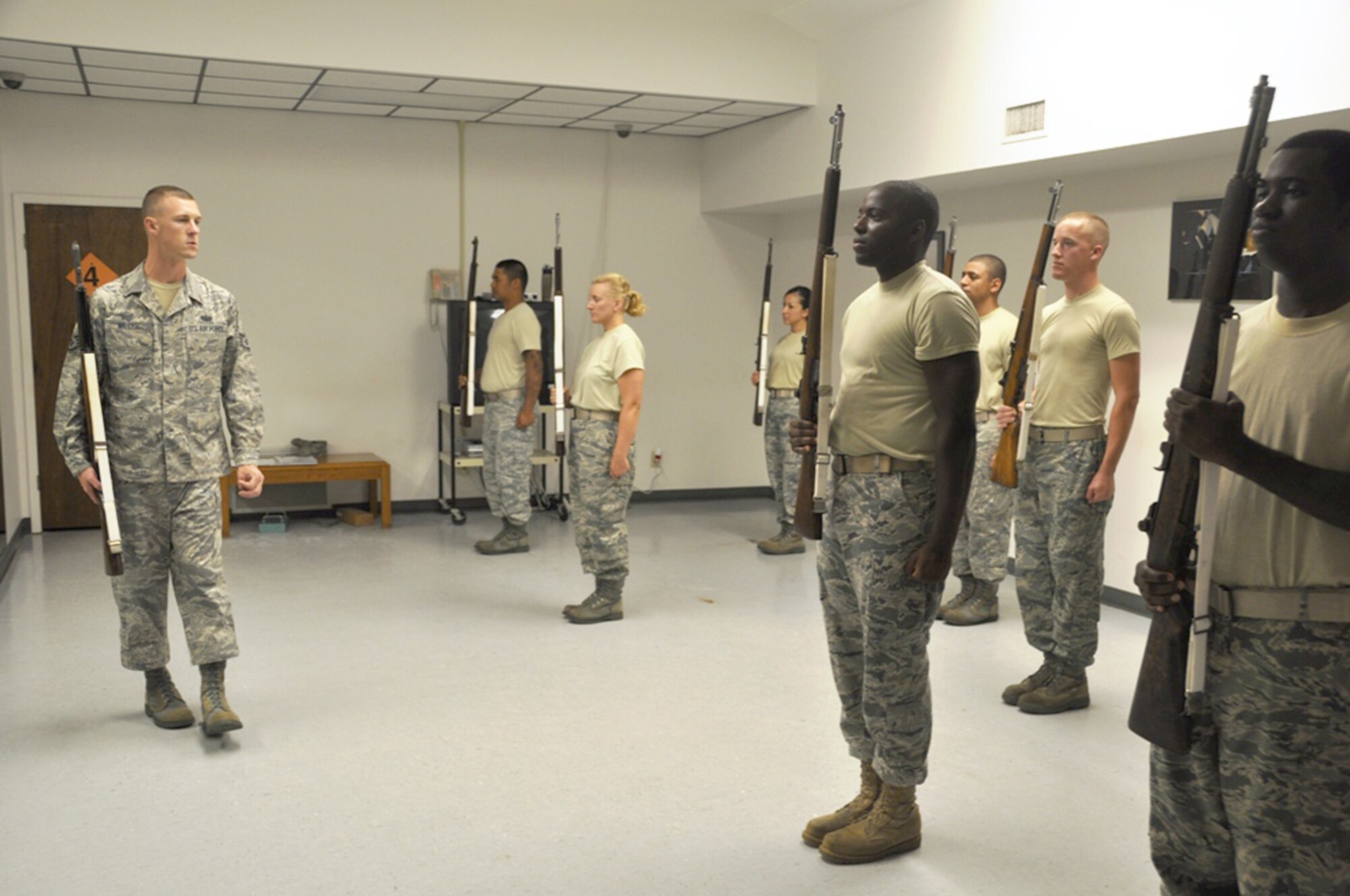 Staff Sgt. Anthony Miller works with Tyndall Air Force Base Honor Guard Airmen to practice for active-duty funeral ceremonies July 21, 2010, at Tyndall AFB, Fla. Airmen participated in a week-long training course to improve their skill and give them the ability to teach others. Sergeant Miller is a visiting United States Air Force Honor Guard instructor. (U.S. Air Force photo/Senior Airman Kirsten Wicker)